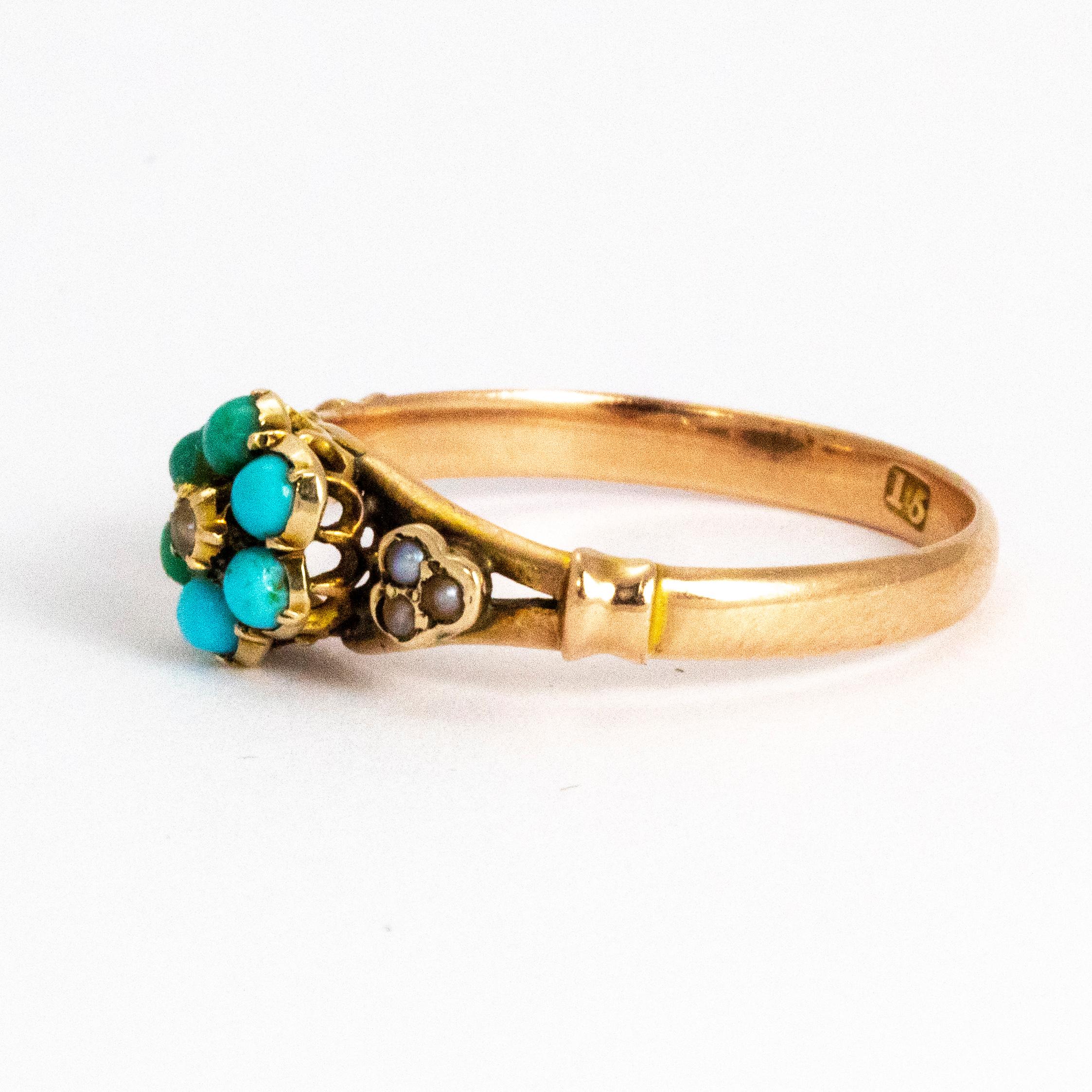 Beautiful mid 19th century turquoise cluster ring. In the middle of the turquoise cluster sits a dainty little pearl and this ring also features pearl shoulders. Modelled in 15ct gold, this ring has a beautiful openwork setting on which the cluster