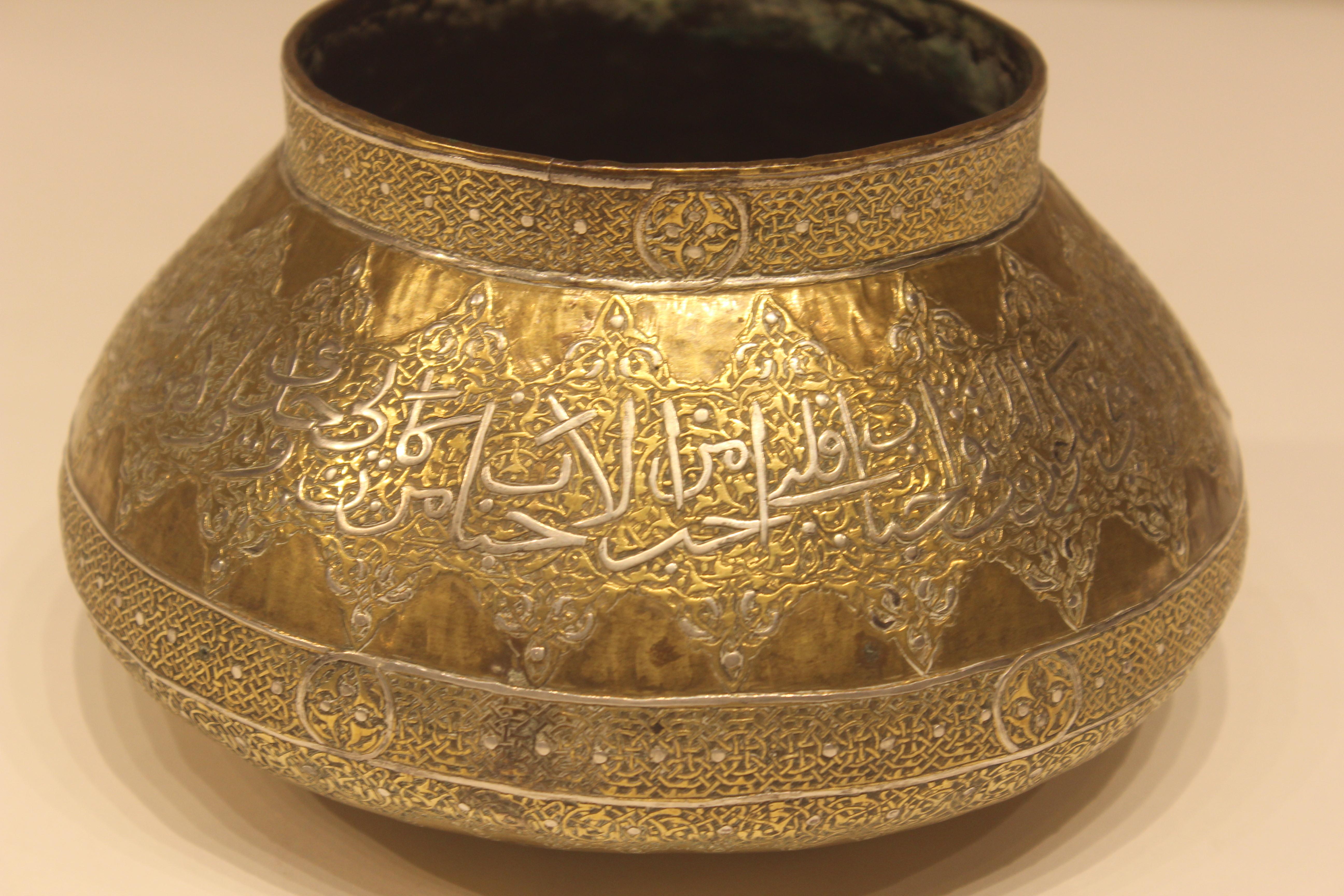 Mid-19th century unusual Mamluk brass filigree bowl. Inlayed silver Arabic filigree surrounding the surface of pot with great detail. Done by hand and signed at bottom.