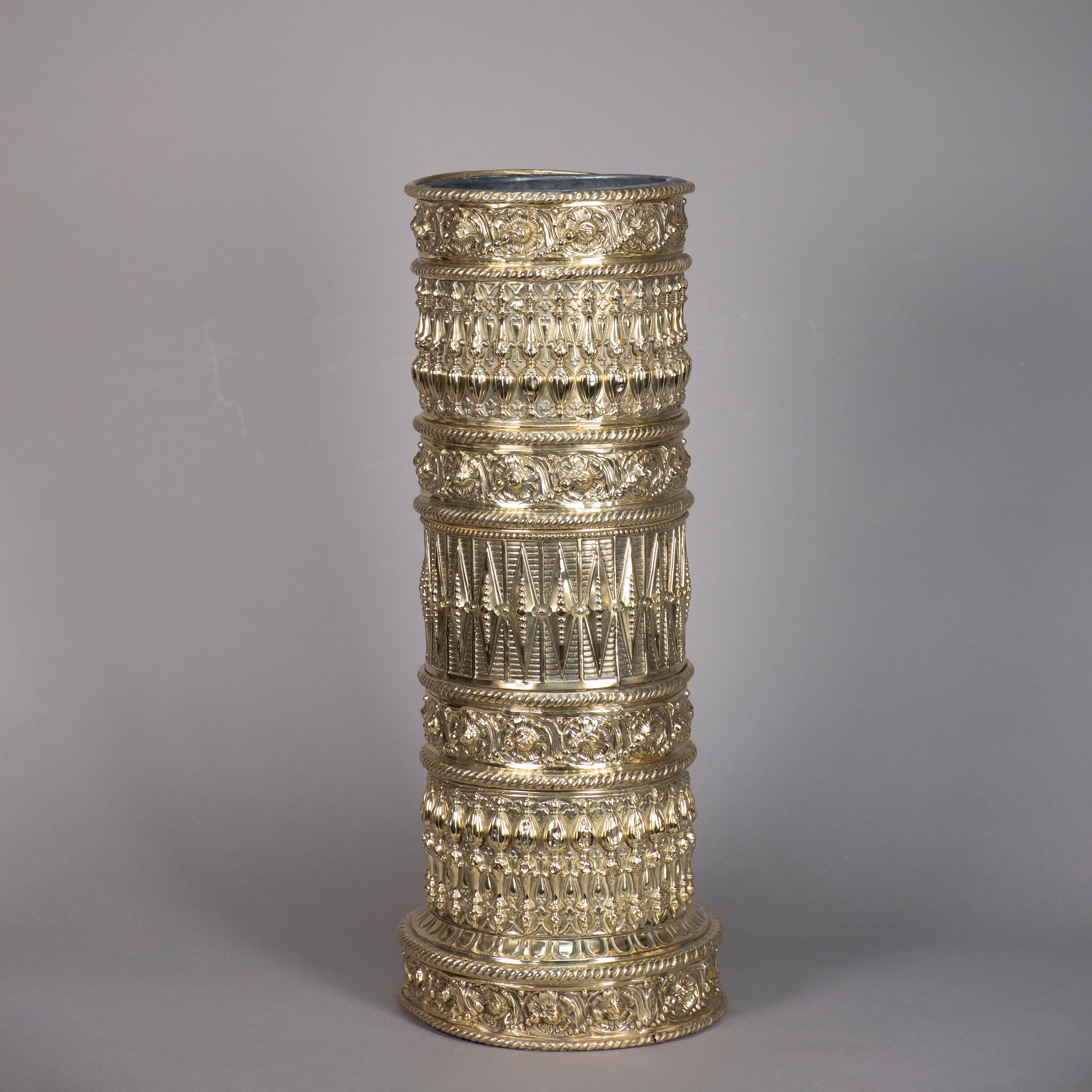 A rare mid-19th century Victorian Period repoussé brass stick stand or umbrella stand of cylindrical form and decorated throughout with elaborate geometric motifs. Retaining the original zinc liner.