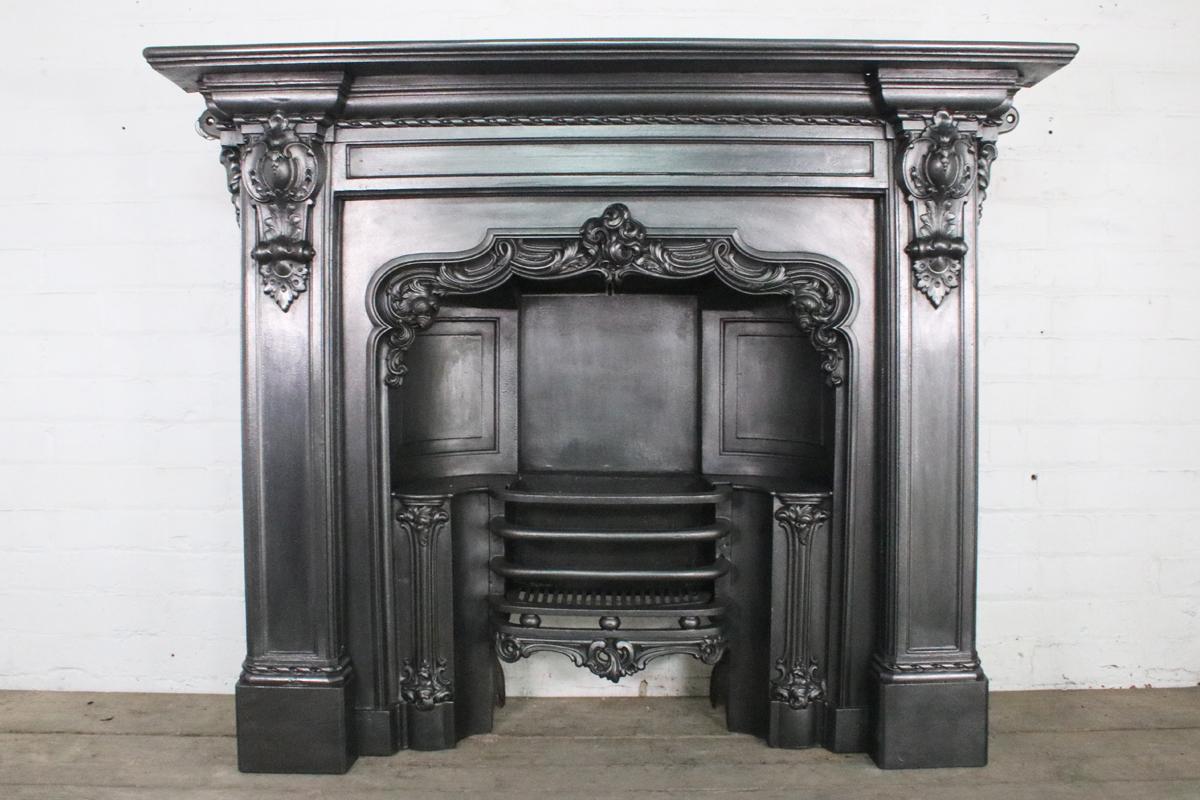 Mid-19th century Victorian cast iron fireplace surround with decorative cast corbels supporting the shelf. This design was registered on 22nd January 1864 and was protected for a further 3 years.

Pictured with a William IV cast iron grate, sold