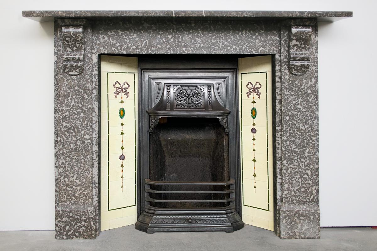 Mid 19th century Victorian Derbyshire limestone fireplace surround with geometric corbels supporting the shelf. Circa 1850.

Pictured with a cast iron and tiled insert and a free standing fire basket, priced separately.

For detailed sizes