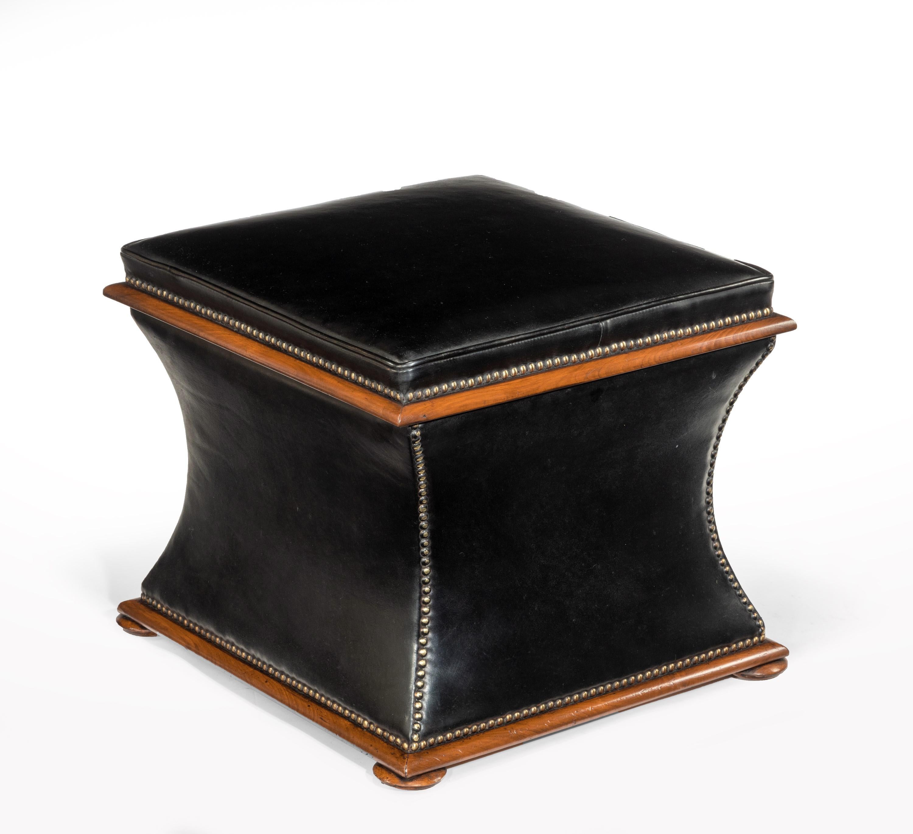 A well sized early Victorian Sarcophagus shaped walnut ottoman upholstered in leather on bun feet.

English, circa 1850.

The padded piped edge leathered top having a brass nailed finished and walnut moulded trim opens to reveal a useful lined