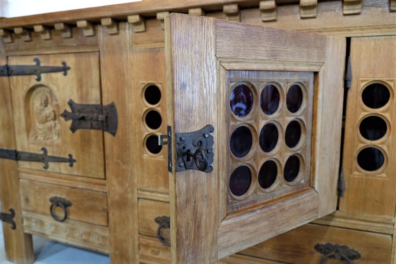 Beautiful craftsmanship from the carved detailing to the iron straps and hinges can be found on this wooden serving cabinet. Imported from Belgium.