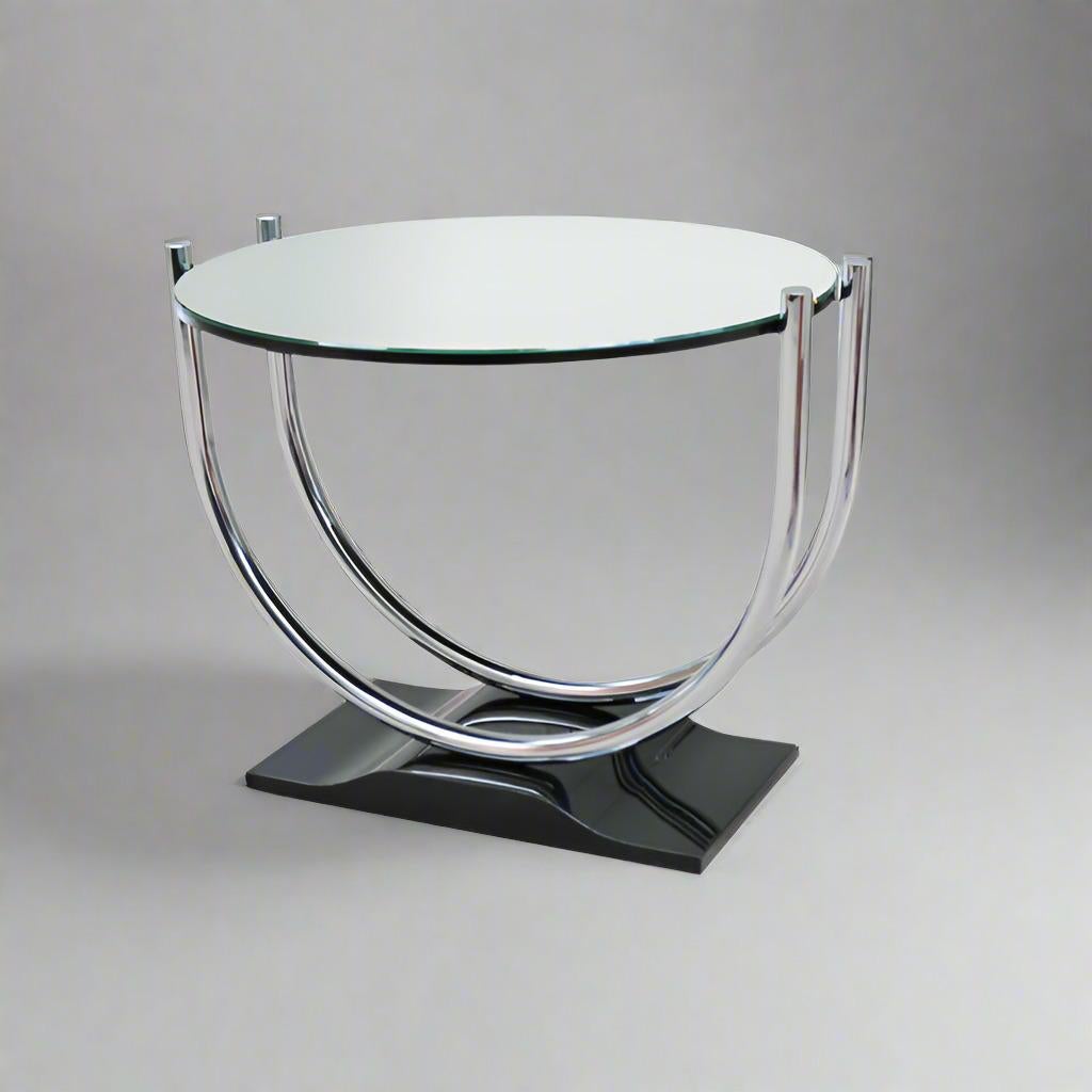 A French Art Deco period round side table from France circa 1930. The  Black lacquer base supports a double U shaped polished nickel frame enclosing a circular mirrored top.