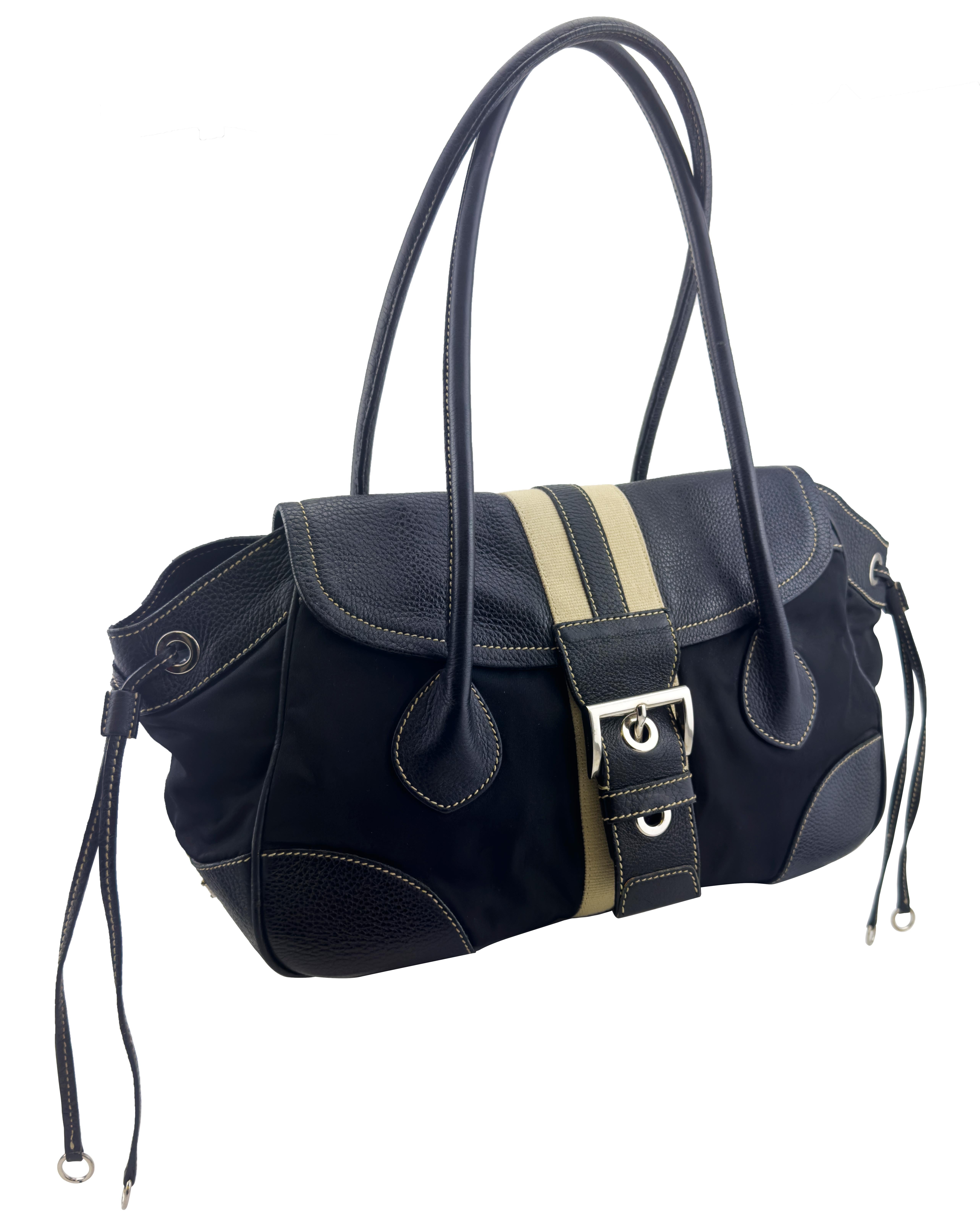 Prada Vitello Daino black nylon and leather elongated double top handle bag from the mid 2000’s. Beige canvas stripe in the centre. Flap front with large silver metal buckle. Contrasting beige top stitching throughout. Drawstrings on sides that can