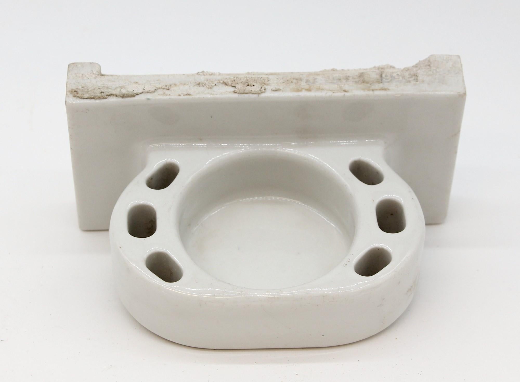 Mid-20th century ceramic white recessed cup dish with slots for six toothbrush holders.