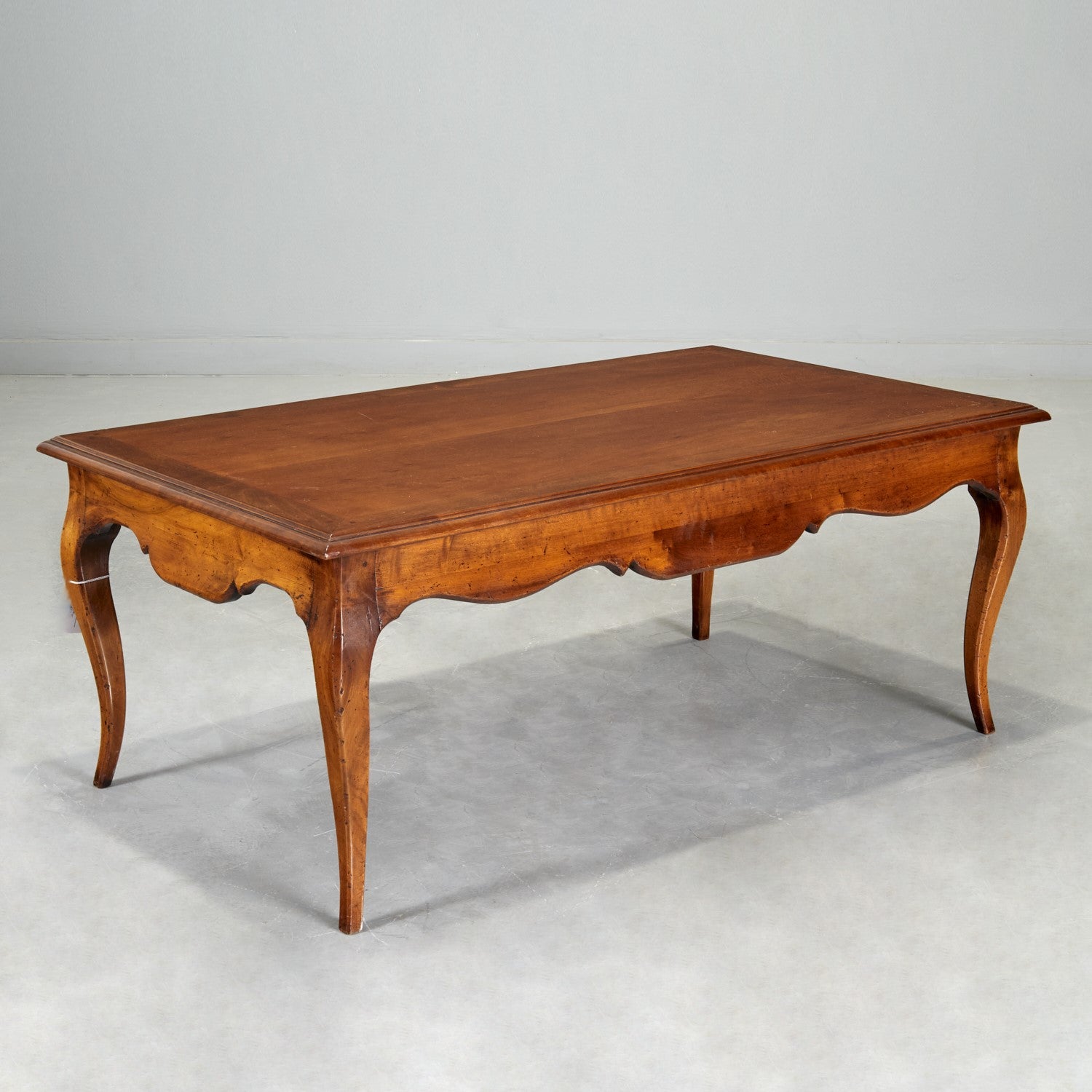 Mid 20th c., French Provincial cherry coffee table with shaped apron, on cabriole legs, stamped 
