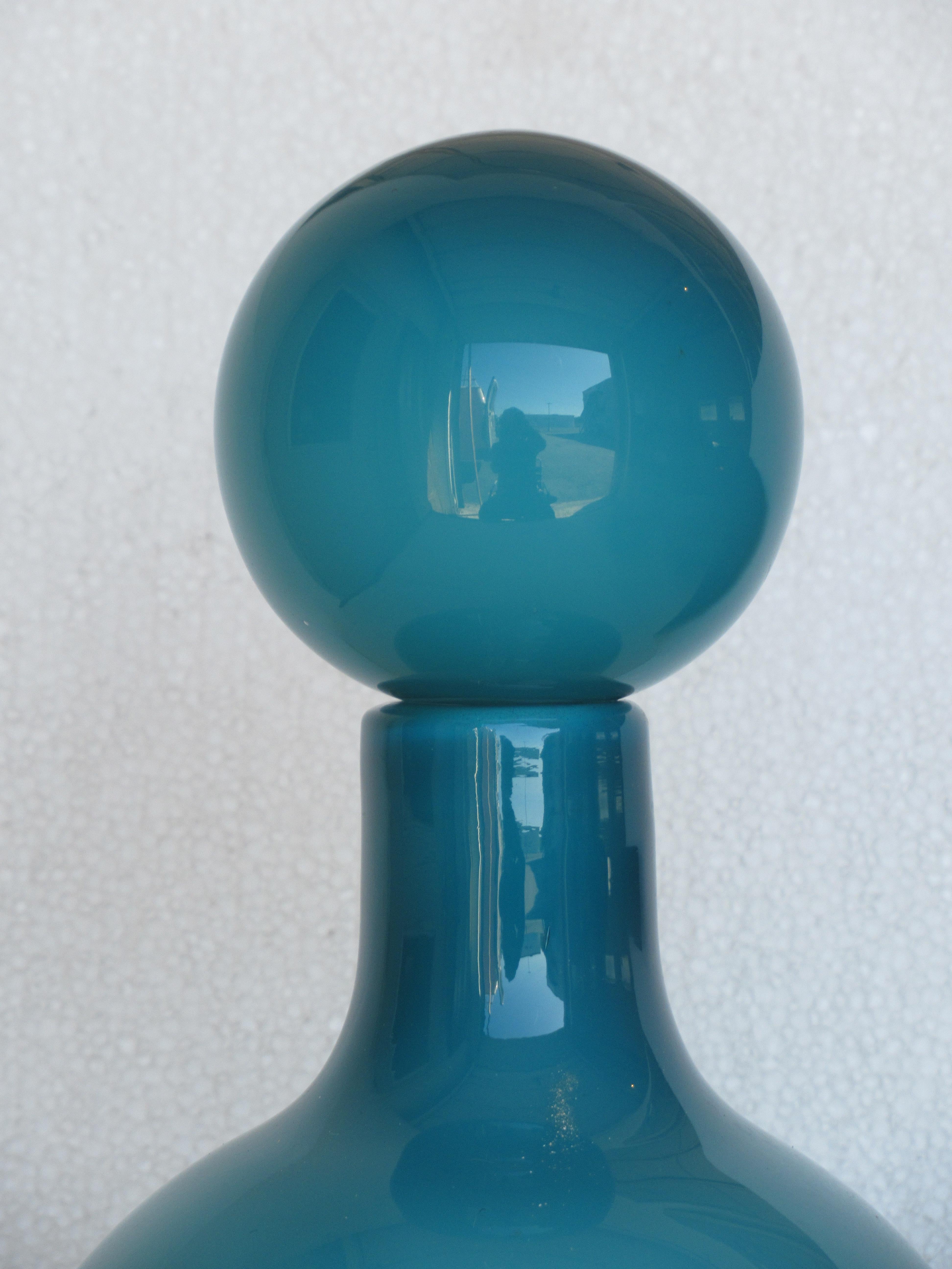 Rich deep turquoise with white interior cased glass decanter bottle with large impressive round stopper. Circa 1950-1960. Attributed to Otto Brauer for Holmegaard. This is a beauty.  Look at all pictures and read condition report in comment section.