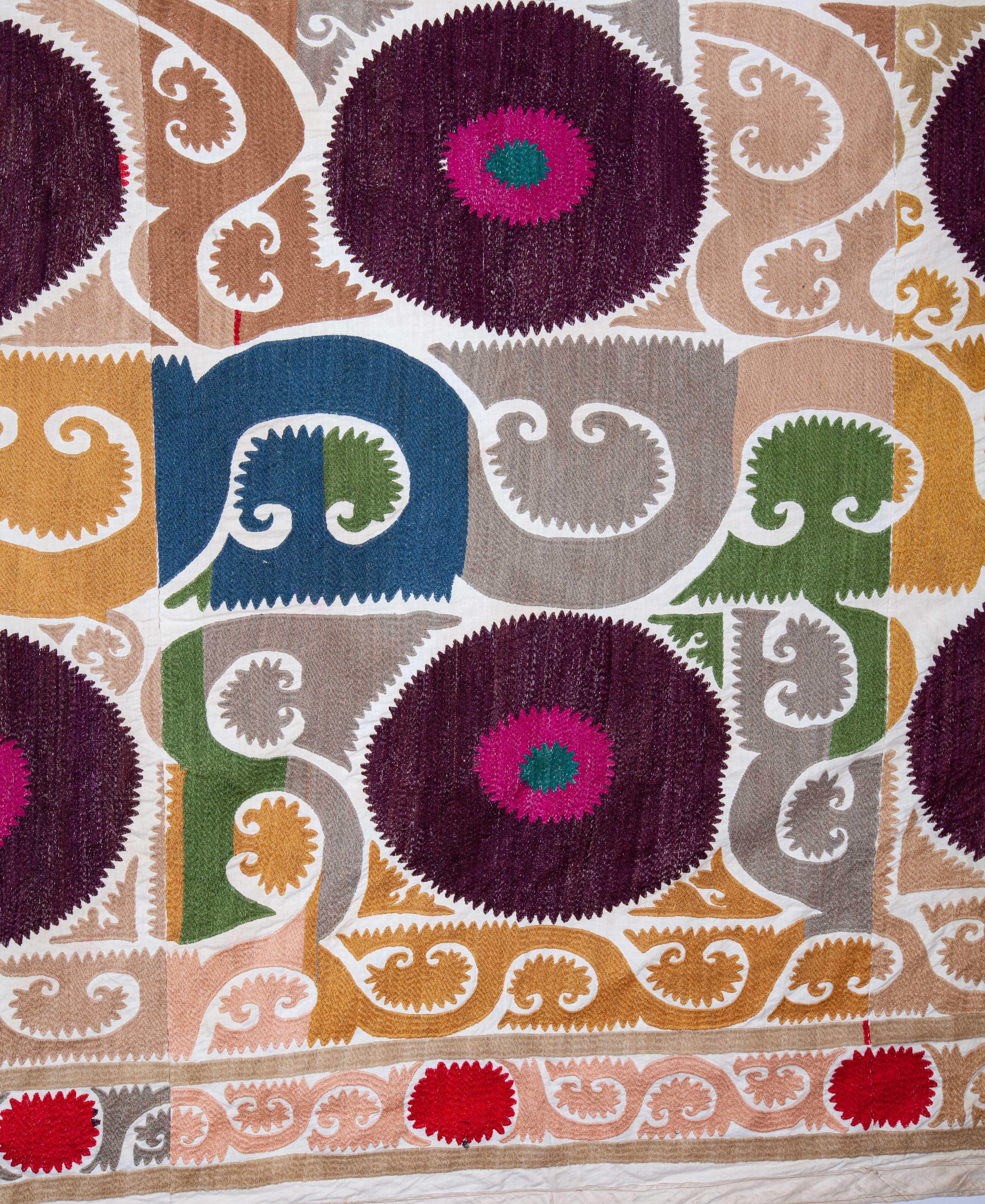 This Suzani has a rather unusual color pallete along with a pleasant design,
mid-20th century.
  