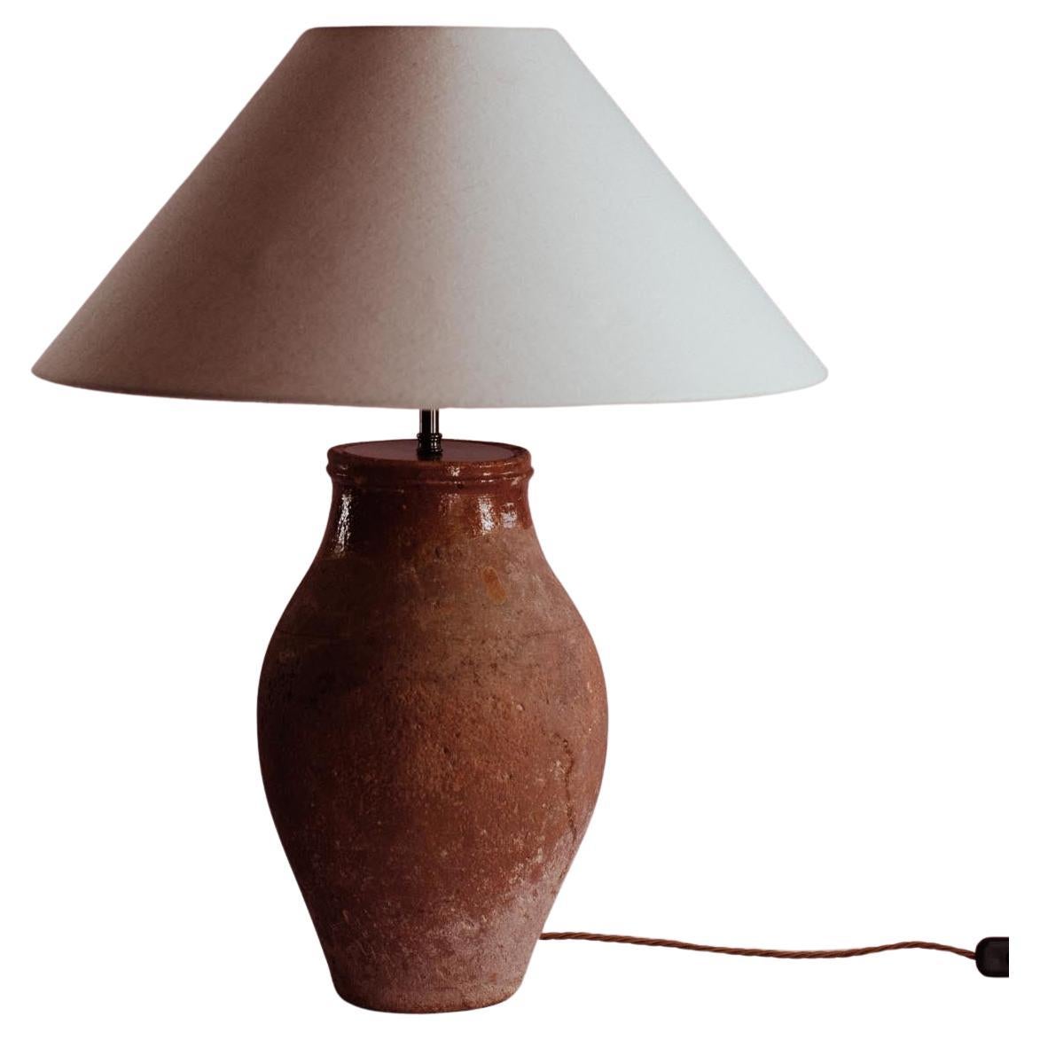 Overview
A mid-20th-century Mediterranean table lamp, handcrafted in Turkey from glazed terracotta. Once a utilitarian vessel, its distinctive worn glaze and earthen patina now bring elegance to modern interiors. Professionally converted in the UK,