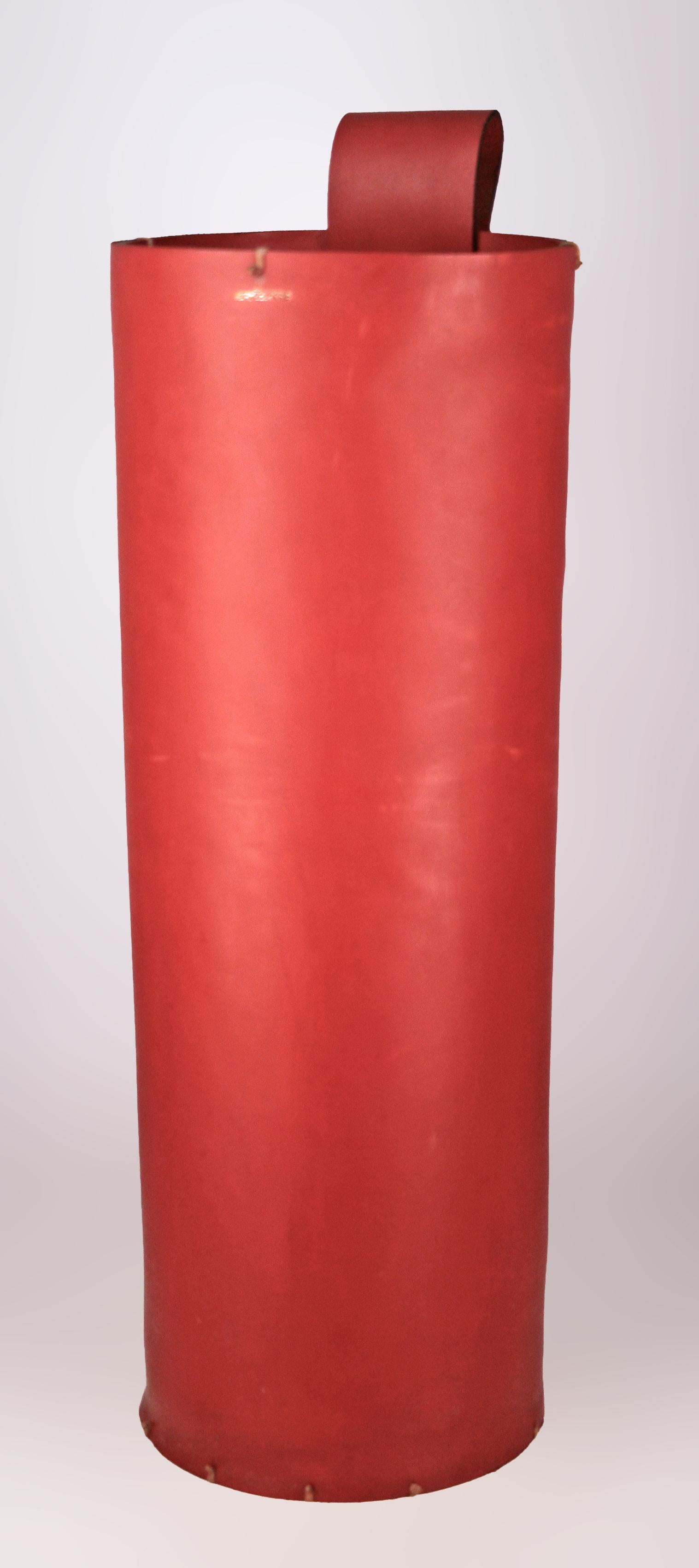 Mid-20th century Modern french red leather cylindrical umbrella stand by Hermès Paris

By: Hermès Paris
Material: leather, thread
Technique: dyed, carved, hand-carved
Dimensions: 8 in x 25.5 in
Date: mid-20th century
Style: Mid-Century Modern, Space
