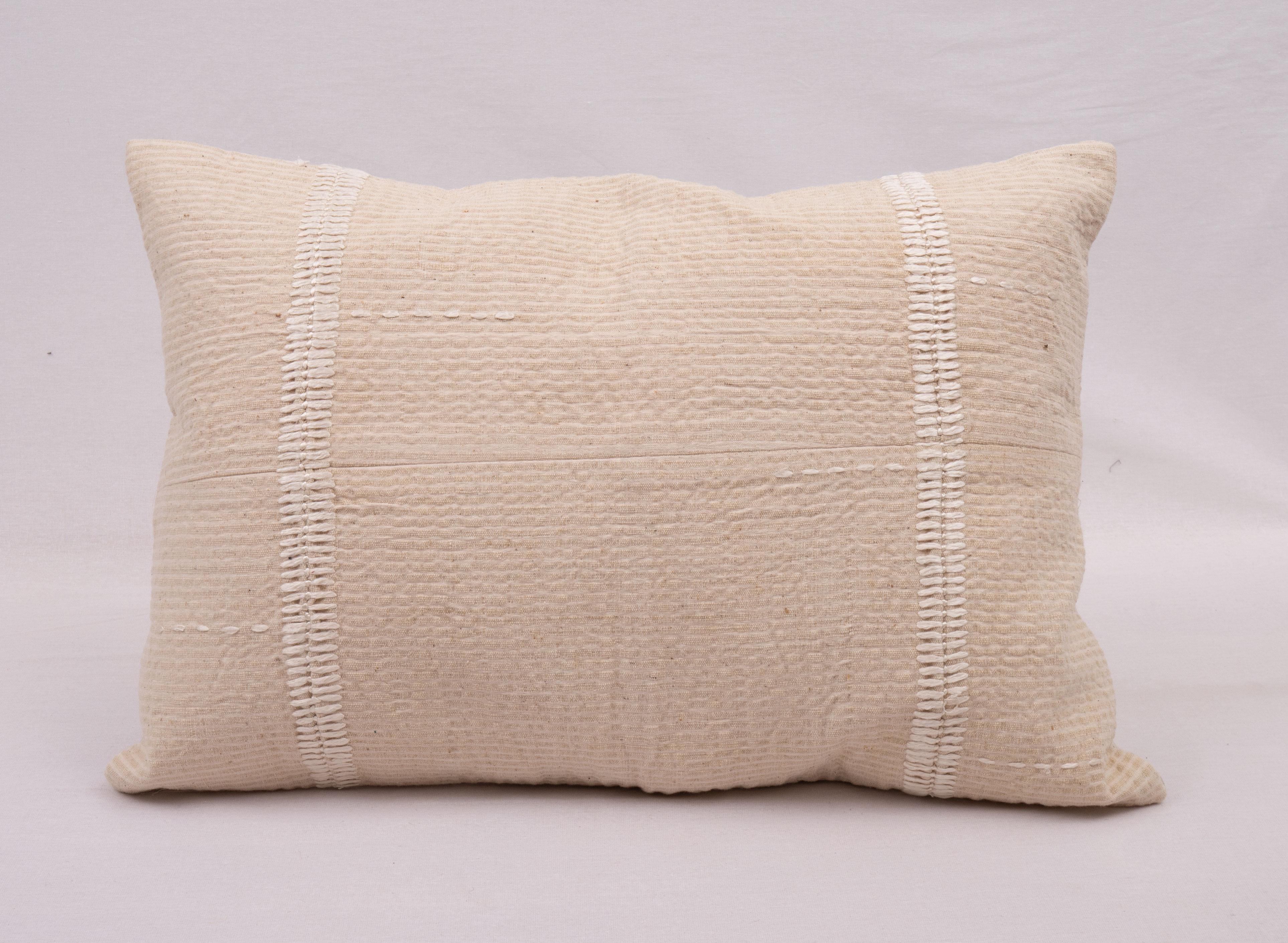 This pillow case is made from a vintage Anatolian Cotton Cover. Hand done silk stitching on it is our addition to the piece to give it a fine detail.

It does not come with inserts.
linen in the back.
Zipper closure.
Dry cleaning is