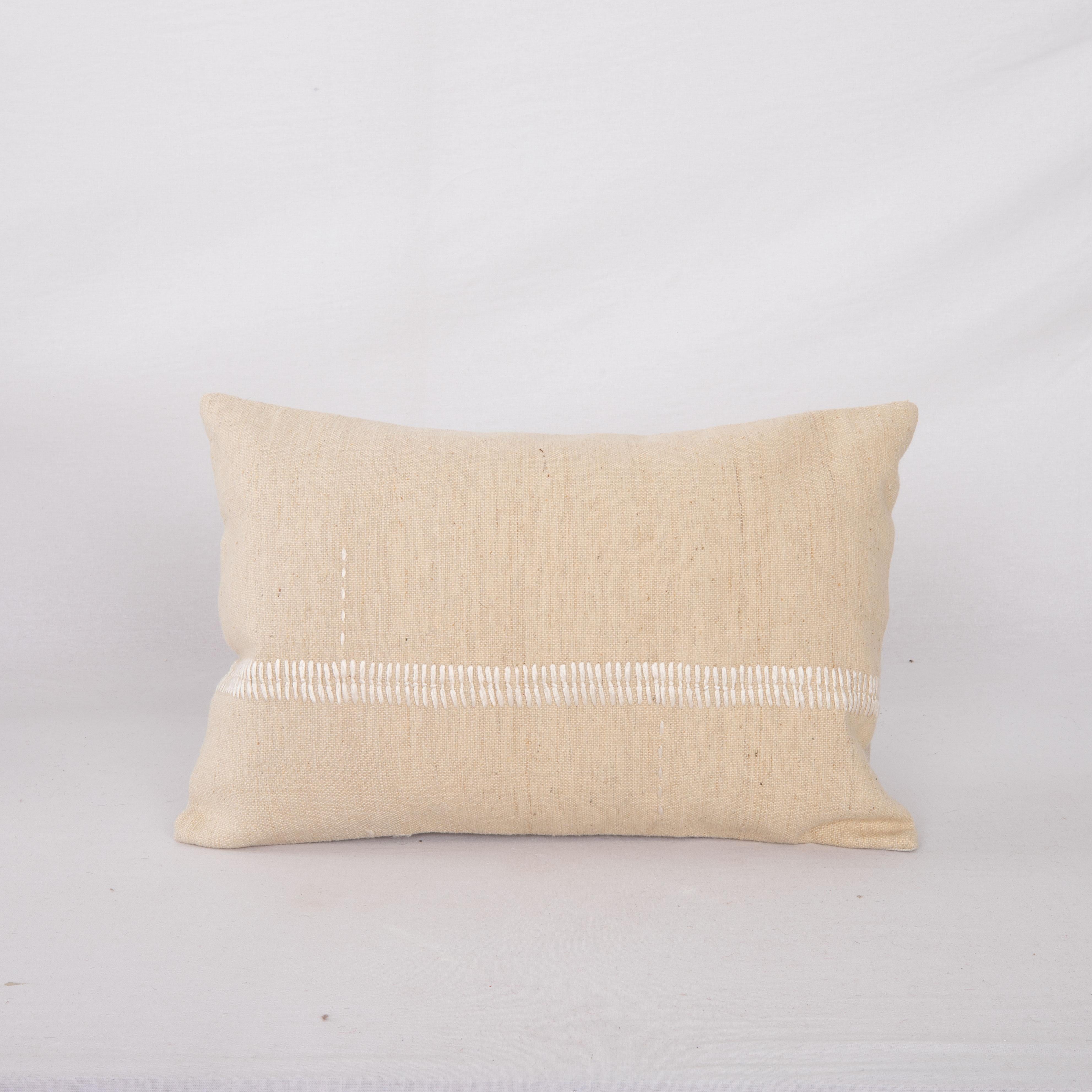 This pillow case is made from a vintage Anatolian Cotton Cover. Hand done silk stitching on it is our addition to the piece to give it a fine detail.

It does not come with inserts.
linen in the back.
Zipper closure.
Dry cleaning is reccommended.
