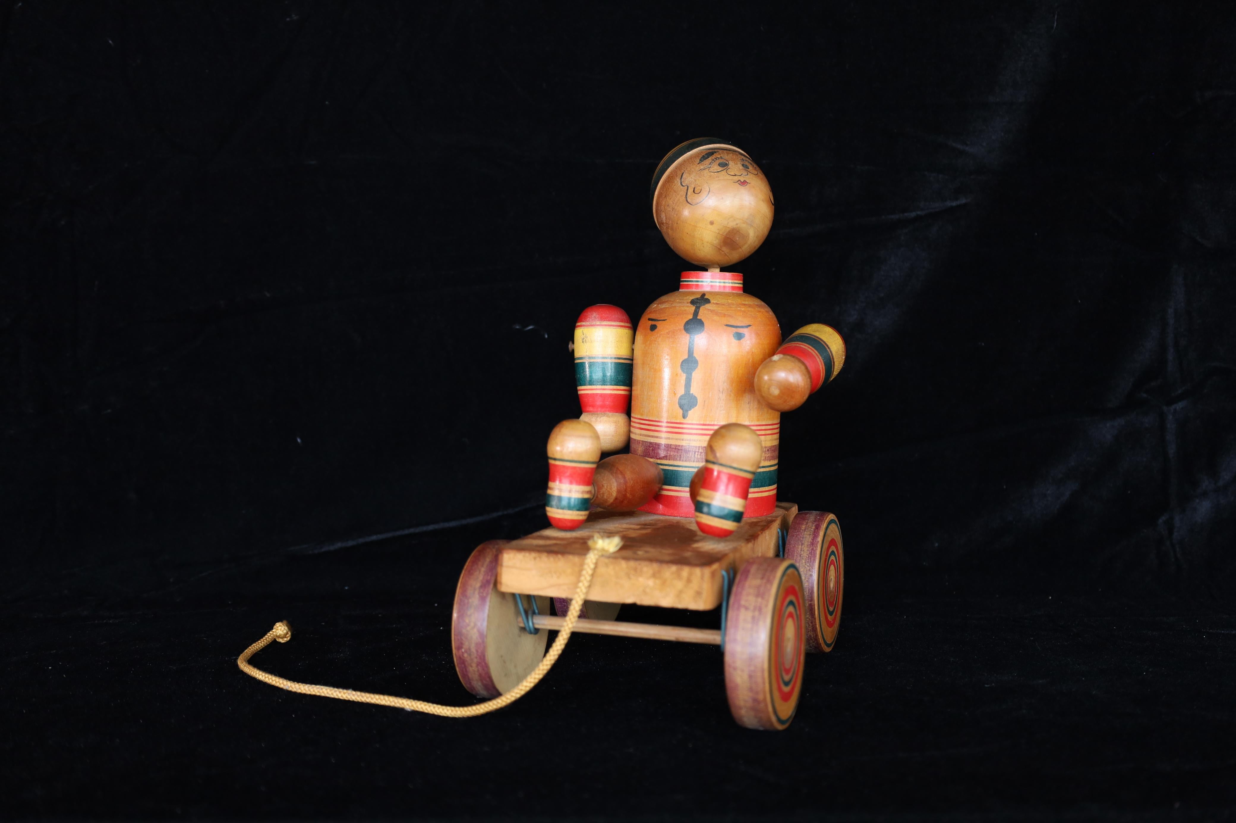 A rare and charming example of kijigangu (traditional Japanese wooden toy), this handcrafted pull toy was created by Fumio Tsuta, the third-generation craftsman of the esteemed Tsuta family. Known for their mastery of wooden toy-making using the