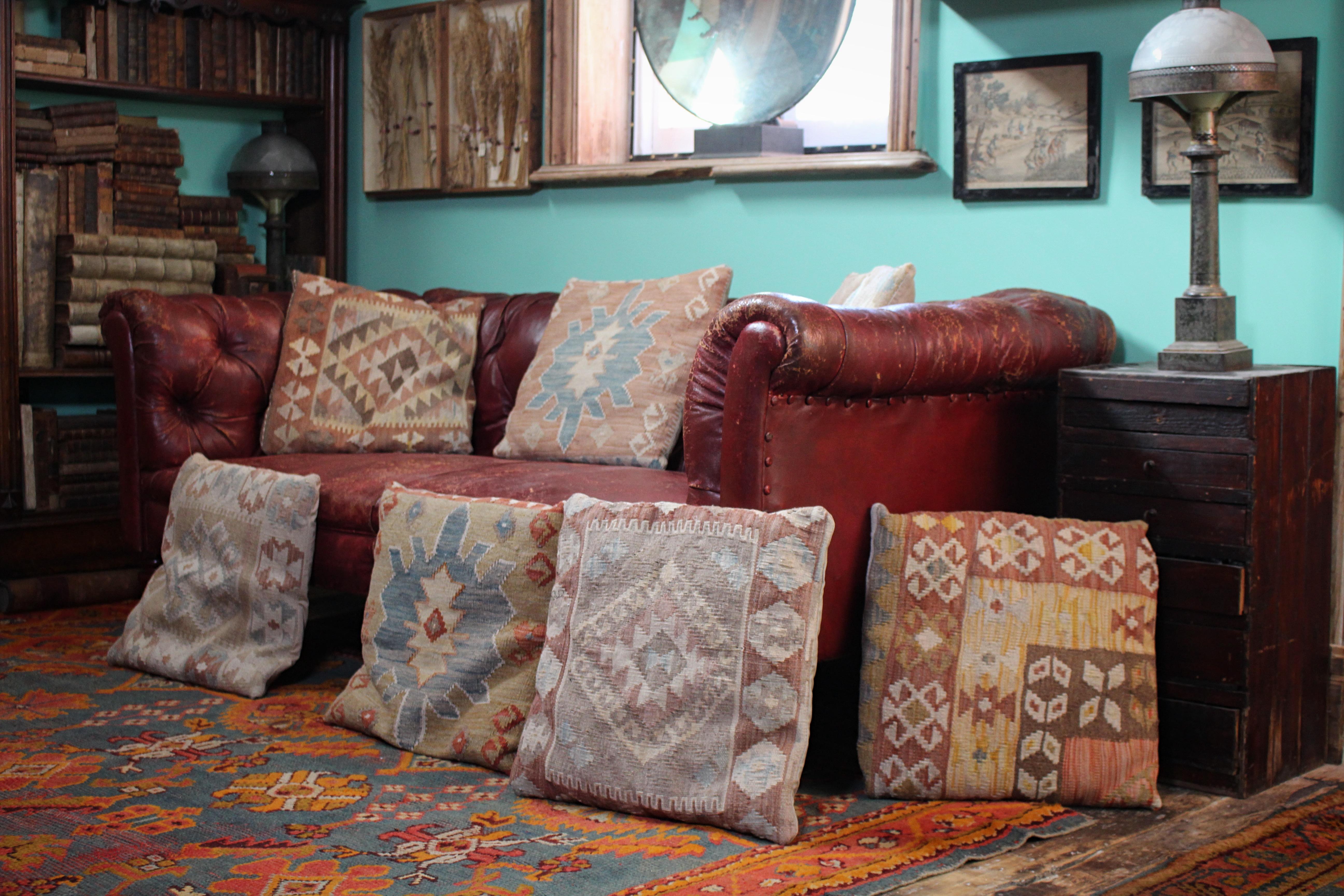 A decorative collection of seven Kilim upholstered scatter cushions, in very much wonderful faded country house condition each approx 42cm square 

Perfectly fit for purpose, mid 20th century in age

Provenance: Property from the estate of the late