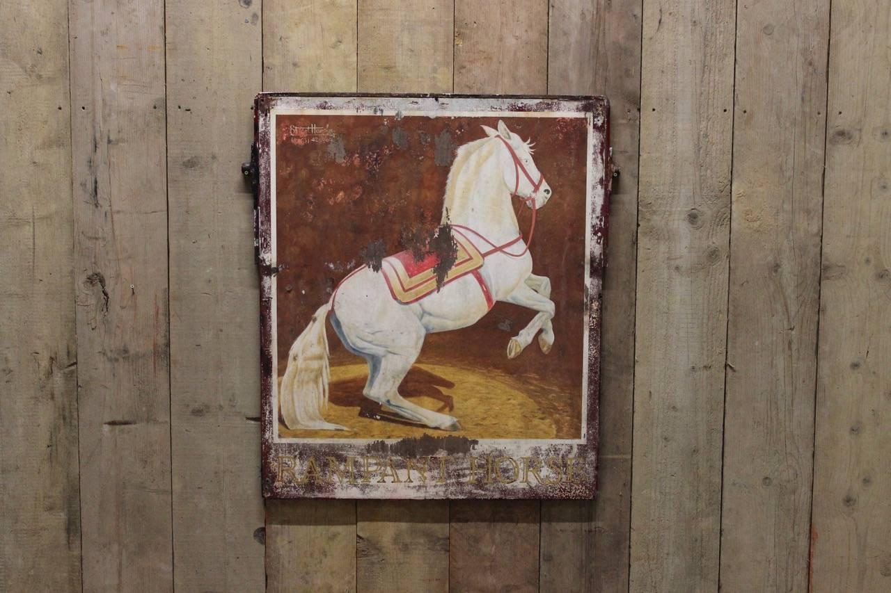 A mid-20th century double-sided, painted wooden and metal-framed pub sign for the 'Rampant Horse'.
 