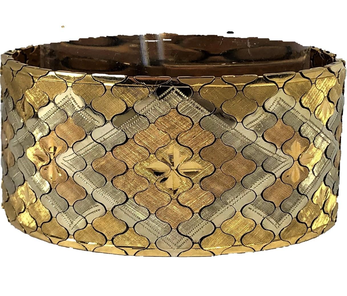 This classic Mid-20th Century, double Florentine, high polished and engraved bracelet measures 1 3/16 inches wide by 7 5/8 inches long. Weighing a hefty 86 grams, this smooth, flat, flexible bracelet feels very
smooth and comfortable to the touch.