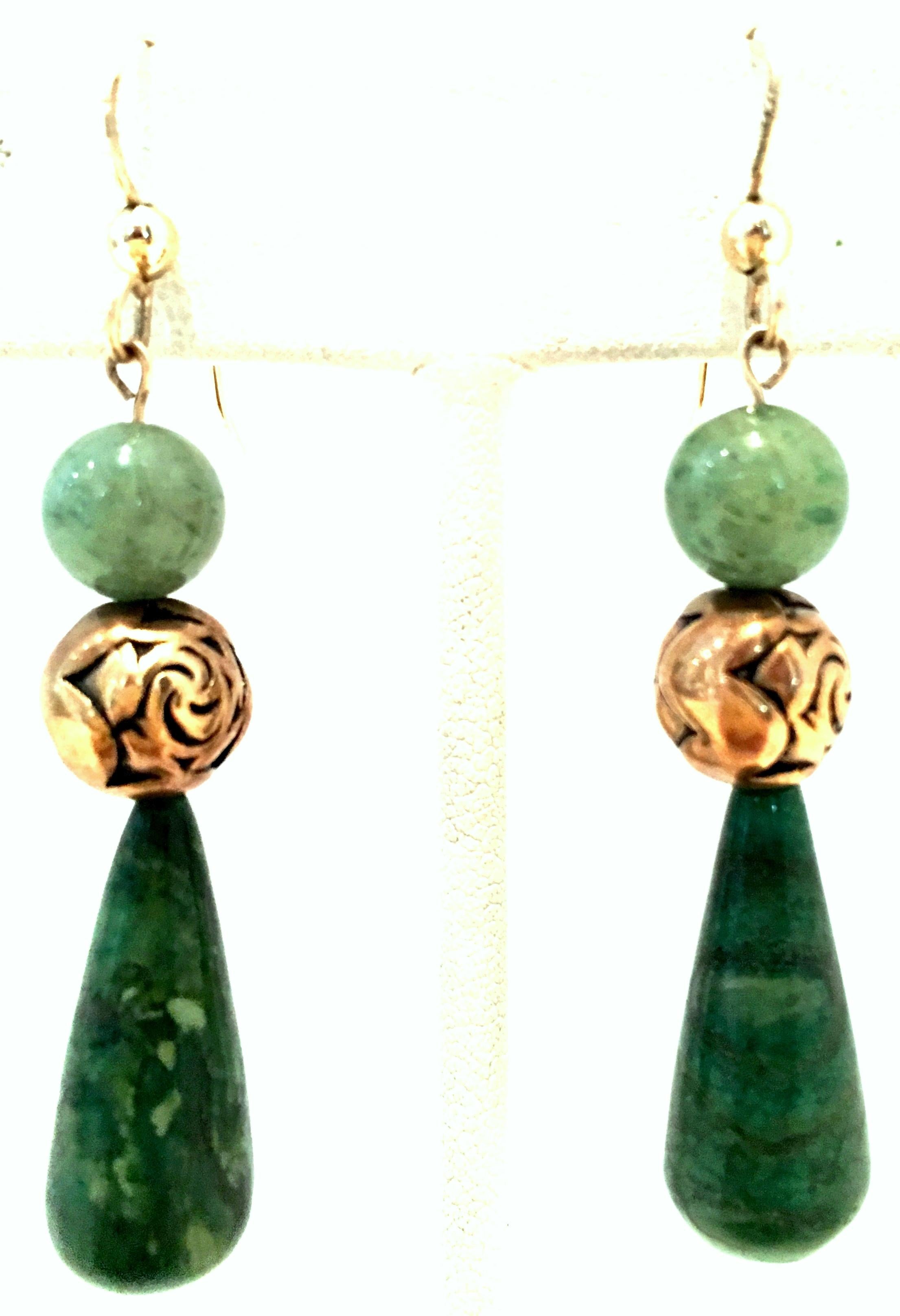 Mid-20th Century 14-K Gold & Jade Drop Earrings. These classic and timeless finely crafted earrings feature polished and smooth green jade with 14K Gold wire posts. The teardrop size is approximately, .75