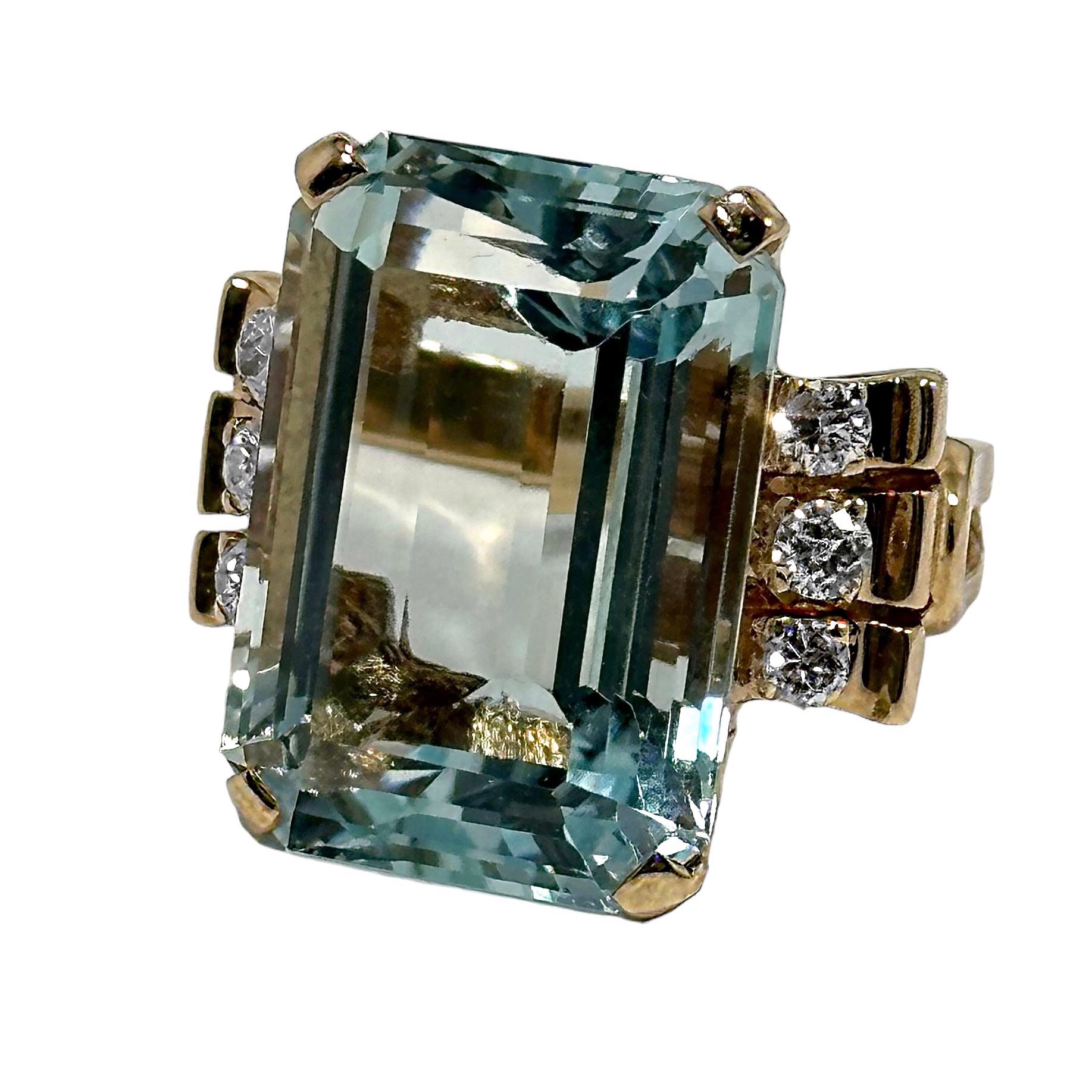 This lovely Mid-20th Century 14k yellow gold ladies cocktail ring is set with one center brilliant, delicate blue aquamarine weighing approximately 23.00ct. This beautiful and large gem is of very high internal clarity. . Flanking the aquamarine are