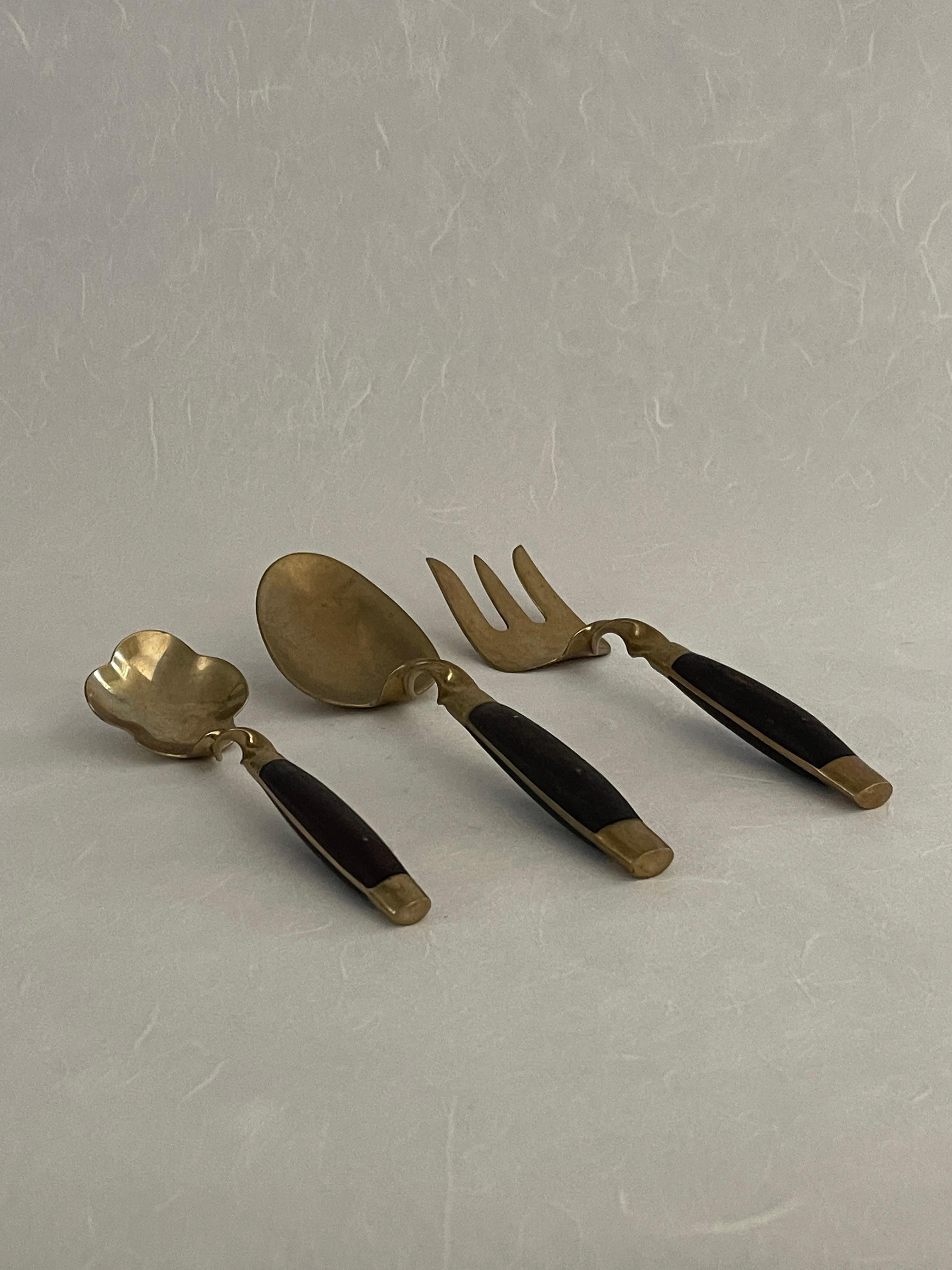 Mid-20th century 42-piece brass and rosewood flatware set. Insanely beautiful 42-piece mid-century brass and rosewood flatware set for a setting of 6. Including 2 butter knives, 1 small serving fork, and 4 large serving utensils. Missing 1 small