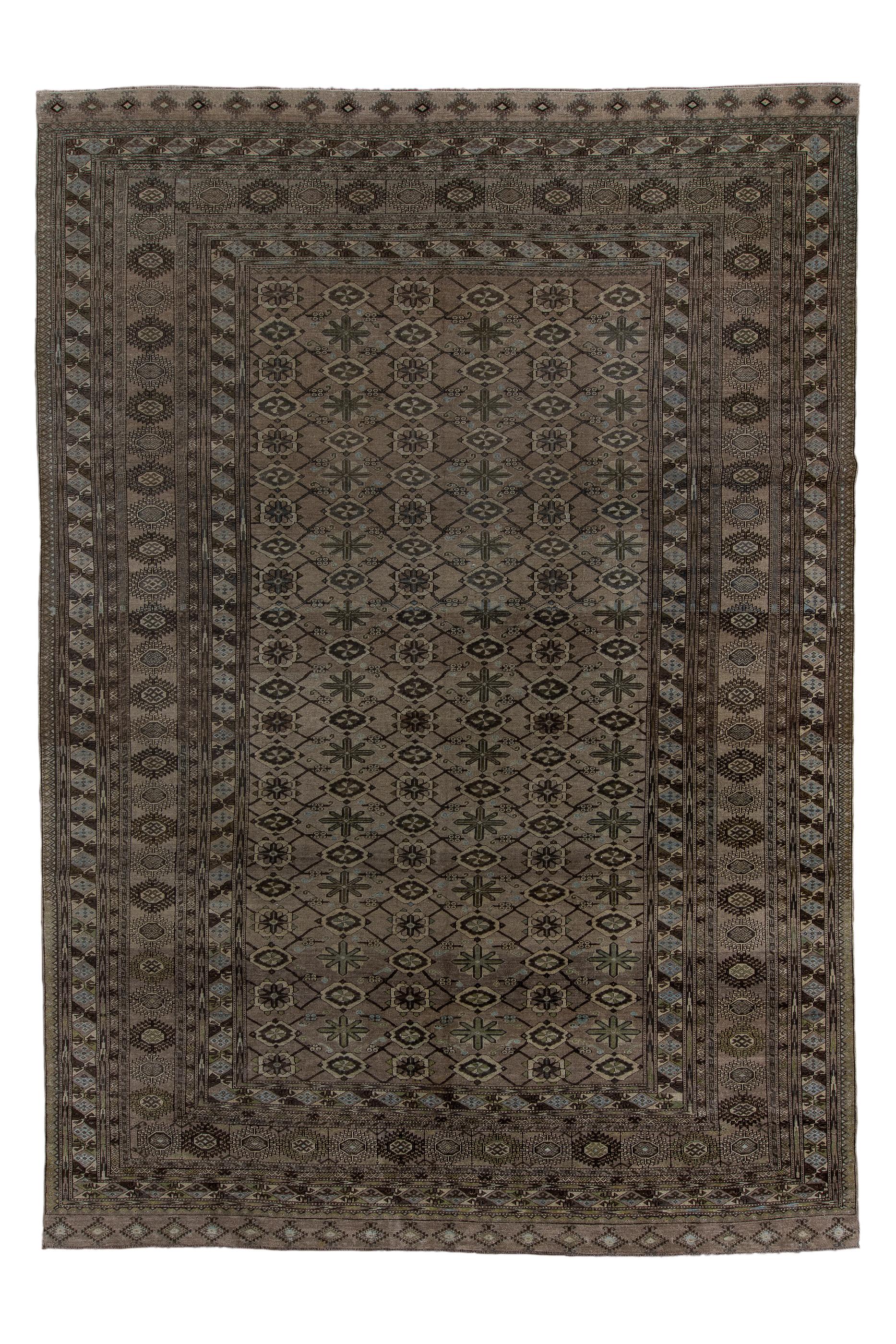 The lighter red-brown field shows a geometric version of the Mina Khani rosette lattice, enframed by a wide border system including a central Tekke-Turkmen-style surround of rayed  hexagons.  Other Turkmen-mode borders include patternings of tuning
