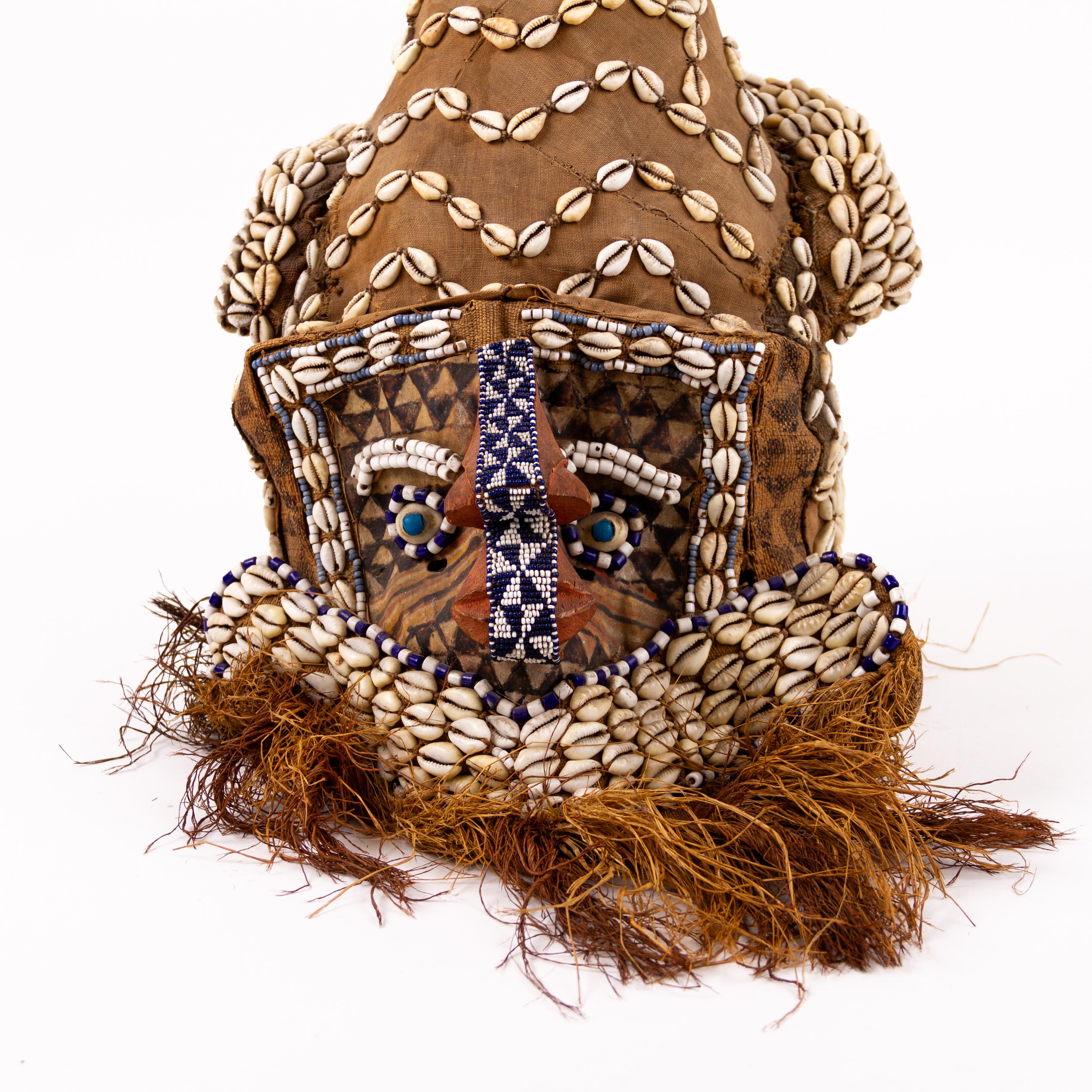 Mid 20thC Kuba Helmet Tribal Mask Shells, Animal Fibres, Raffia

A Kuba helmet refers to a type of ceremonial headgear created by the Kuba people of Central Africa, particularly in the Democratic Republic of Congo. The Kuba people have a rich