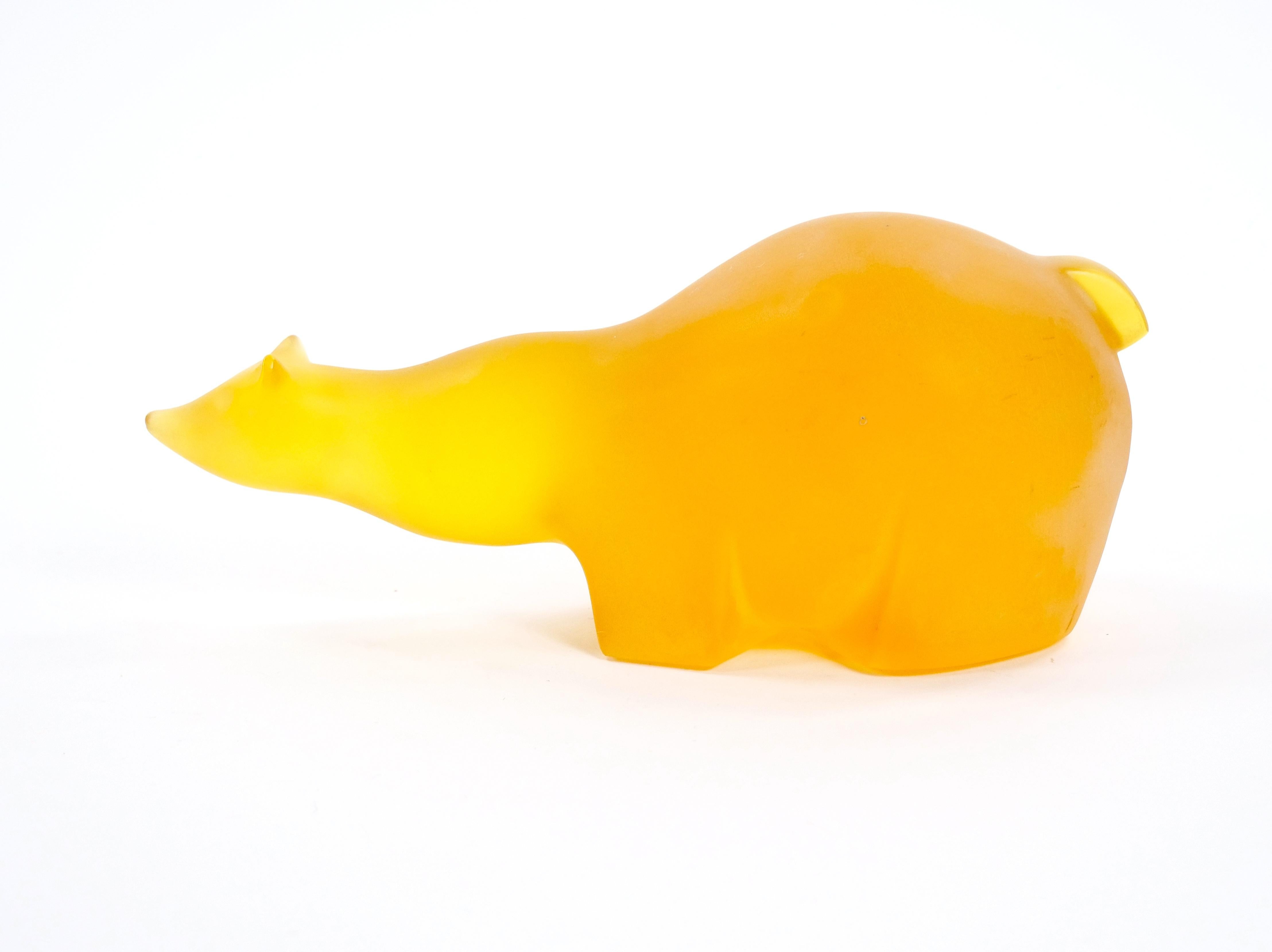 Remarkable mid-20th amber / ice orange composite sculpture showcases a striking polar bear, meticulously crafted with exceptional artistry. The figure is adorned in rich amber tone hues, complemented by a unique ice orange tone sheen that reflects