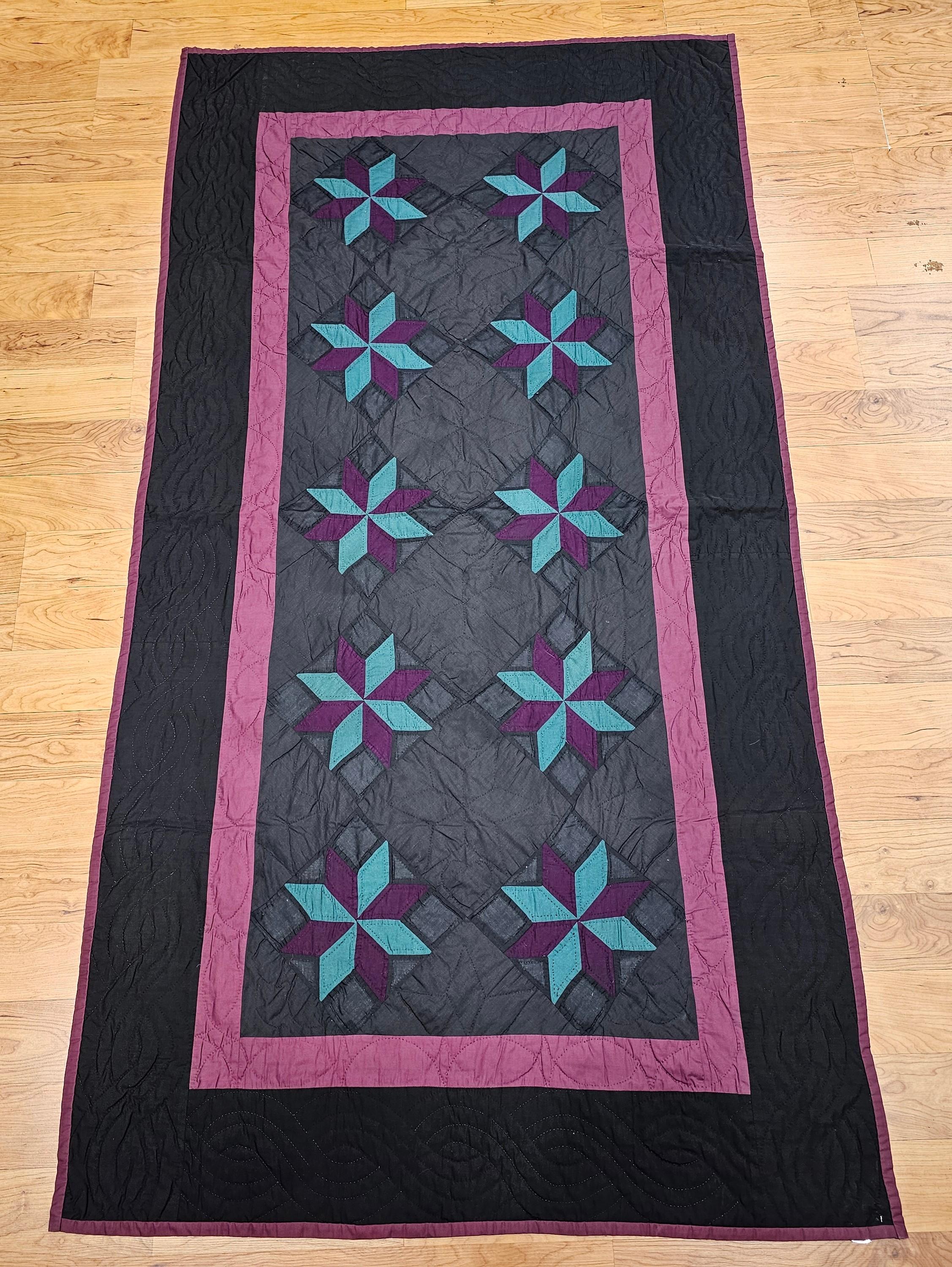 An exquisite mid-20th century hand-stitched Amish quilt from Lancaster County, Pennsylvania, featuring the classic “Lemoyne Star” pattern. This one-of-a-kind piece showcases masterful craftsmanship and an authentic representation of Amish textile
