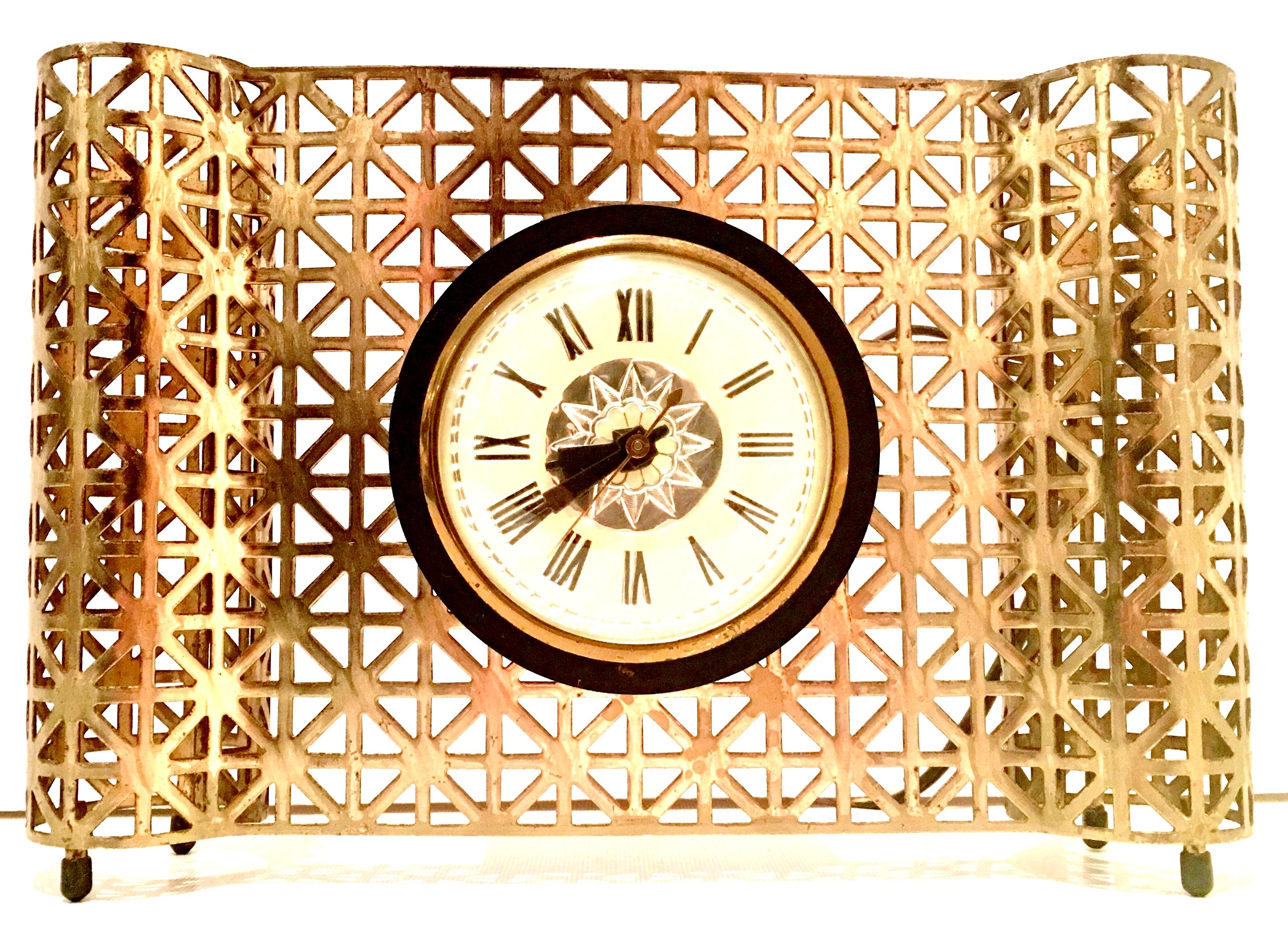 Mid-20th century American Art Deco gilt brass electrified desk or mantle clock by, Bilt - Rite Mfg. Com Inc. Chicago, Illinois. This lovely clock is electrified and operational, wired for the USA. Features a geometric perforated pattern with rubber