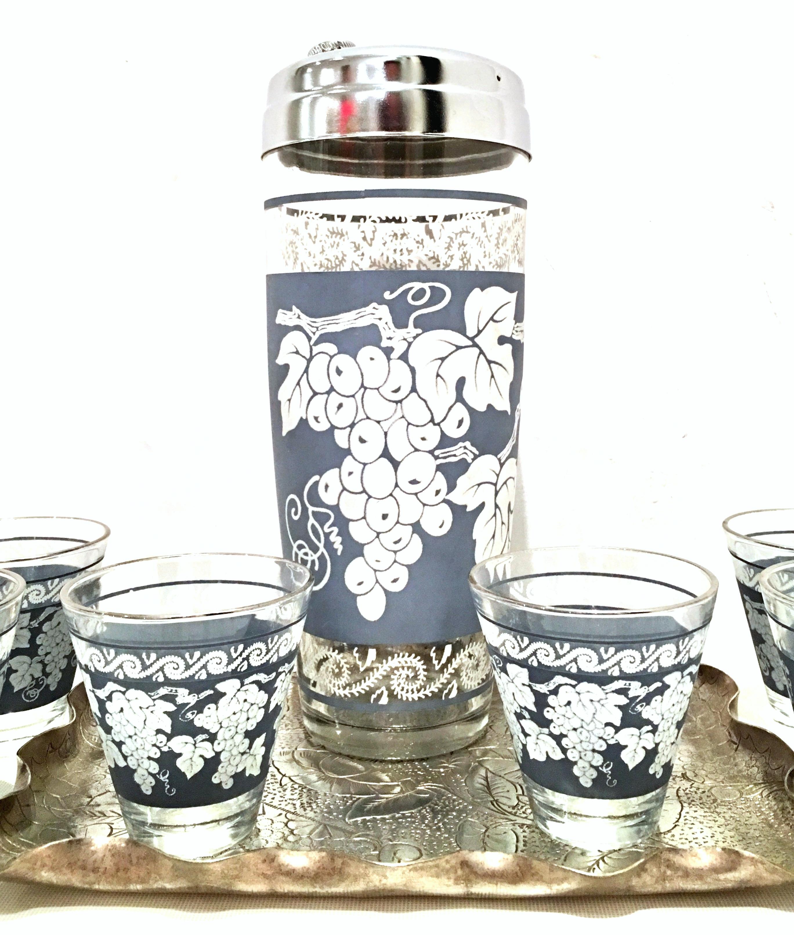 Mid-20th century American blown glass and platinum drinks set of eight pieces. Features a Wedgwood blue and white grape vine motif with platinum and silver chrome details. Set includes, one silver plate Art Nouveau etched leaf motif ruffle edge