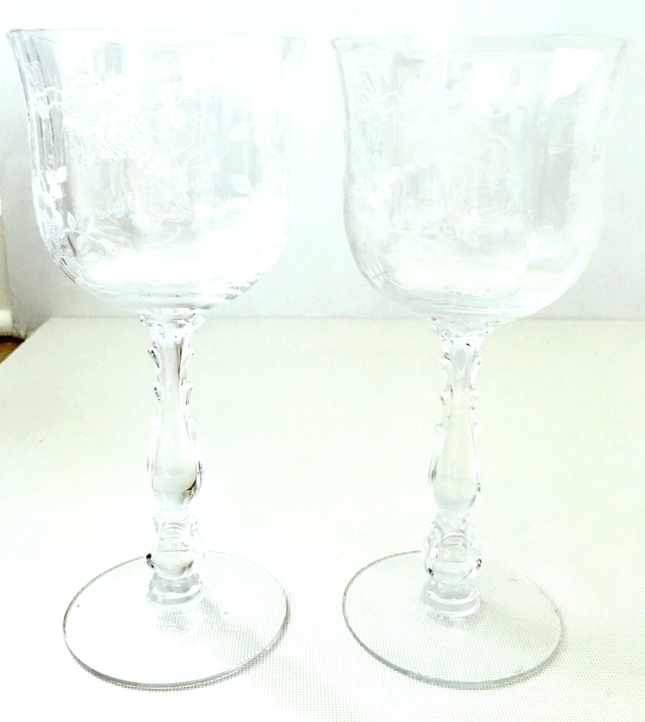 Mid-20th Century American etched crystal stem glasses set of seven pieces. Pattern features and optic shape with rose and vine pattern and cut stem.