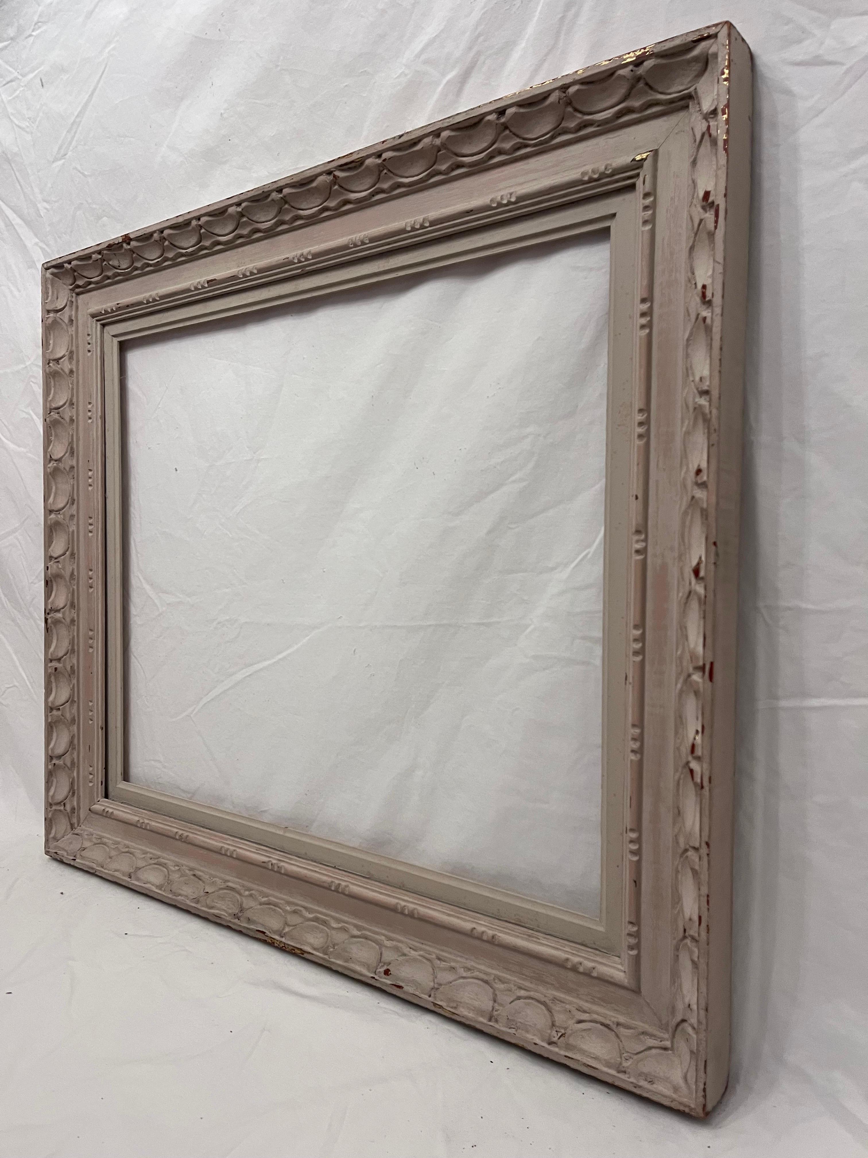 A beautiful and vintage mid 20th century circa 1950's American Modernist style white painted finish picture frame. The rabbet size (size that holds the art) is 24.25