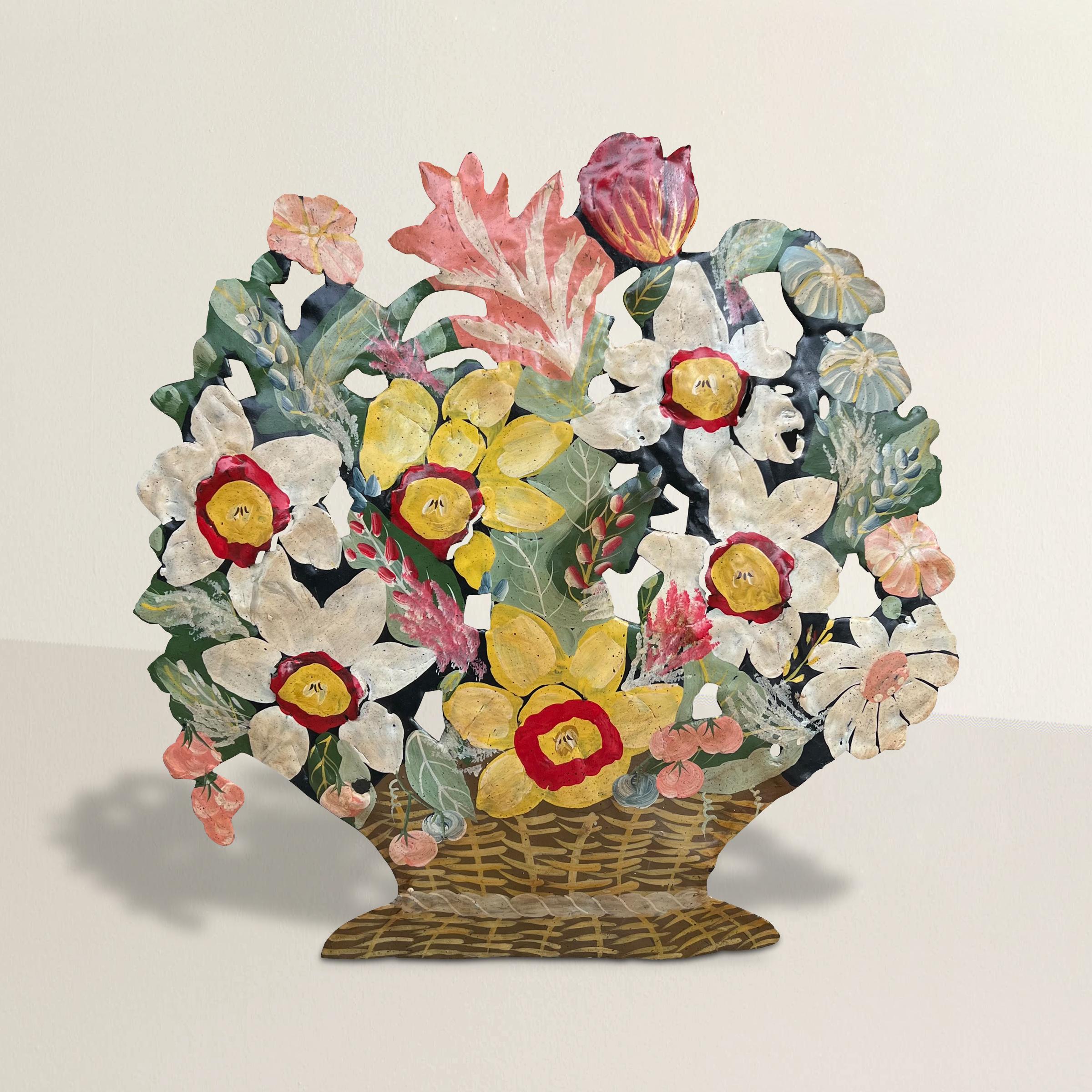 A whimsical mid-20th century American hand-painted tole floral basket doorstop made from cut tin and with some flowers in relief. May also be used as a decorative object on a bookshelf or table top.