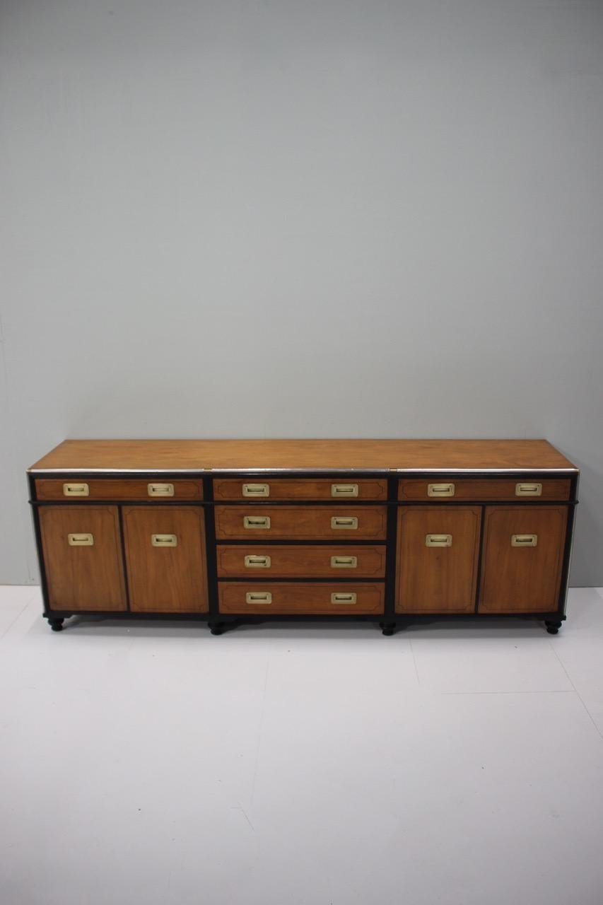 An American, mid-20th century campaign style buffet/ sideboard of great design and quality in Camphor wood with brass military handles.