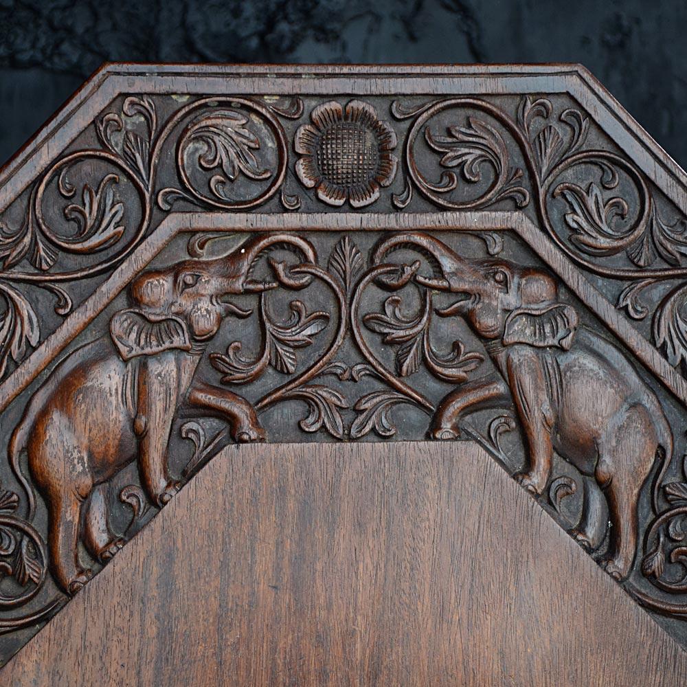 Mid-20th century Anglo-Indian carved elephant table 
We are proud to offer a highly decorative mid- 20th century Anglo-Indian carved hardwood elephant side table. Covered in ornate hand carved figures of elephants and floral motifs. A lovely square