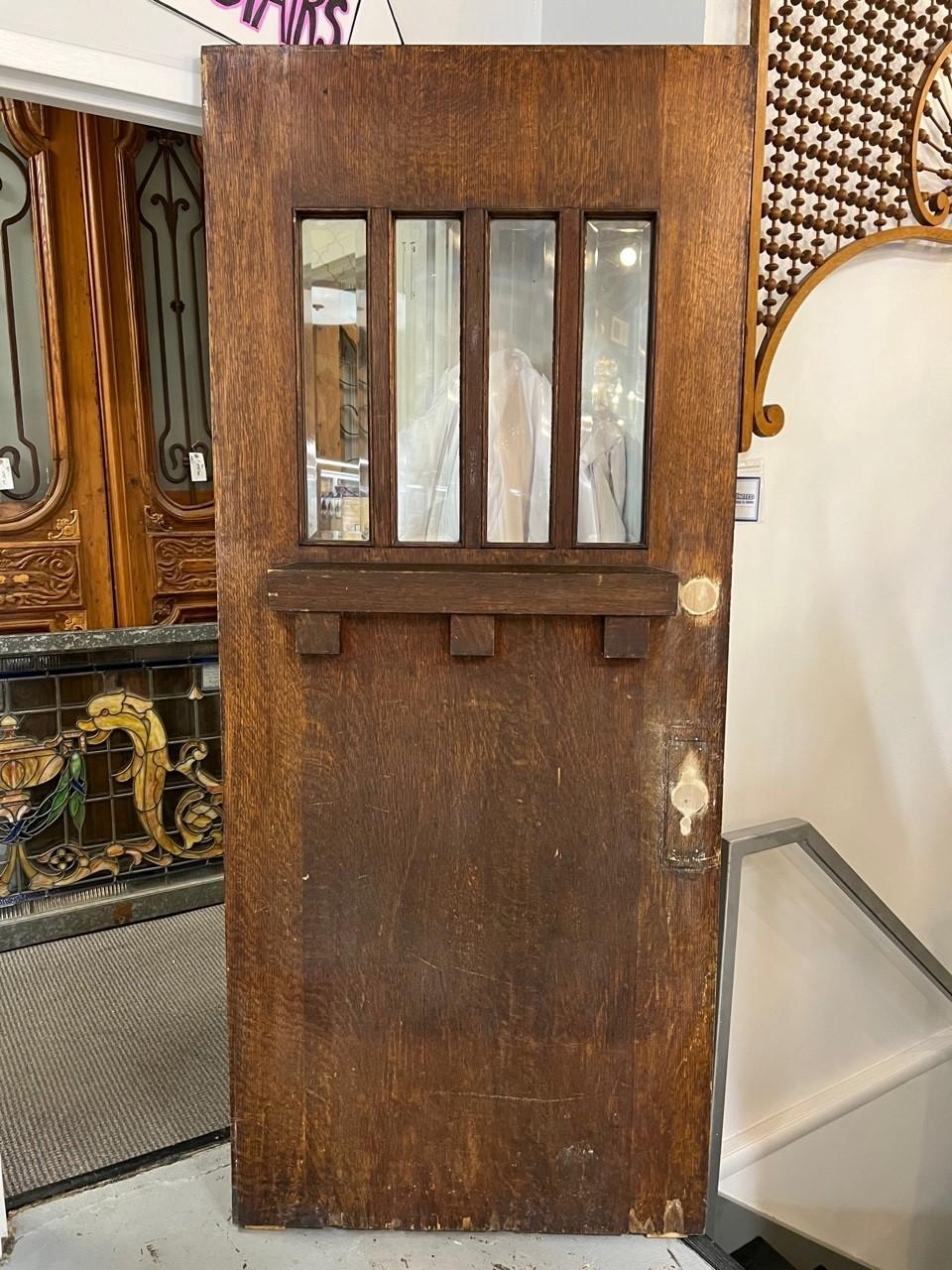 Beautiful Mid 20th century antique Arts and Craft door four lite true divided. This is a great door and a good size for most homes at a good price. The holes have been filled and are ready to be finished. The interior side is in great condition and