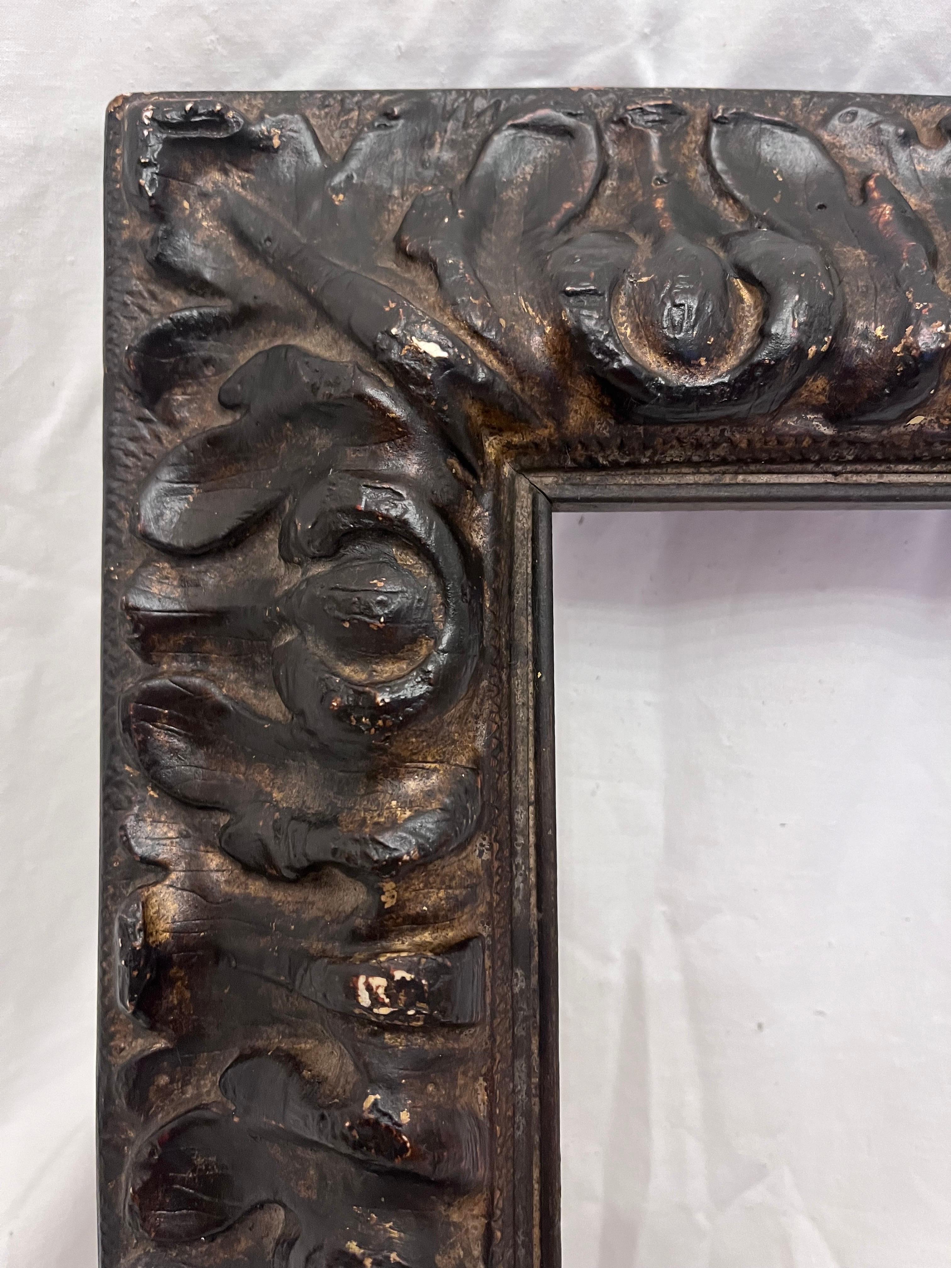 A beautiful and vintage mid 20th century circa 1950's Spanish style reverse stylized foliate picture frame. The molding is higher near the frame opening and slopes down and away from the picture area. The rabbet size (size that holds the art) is