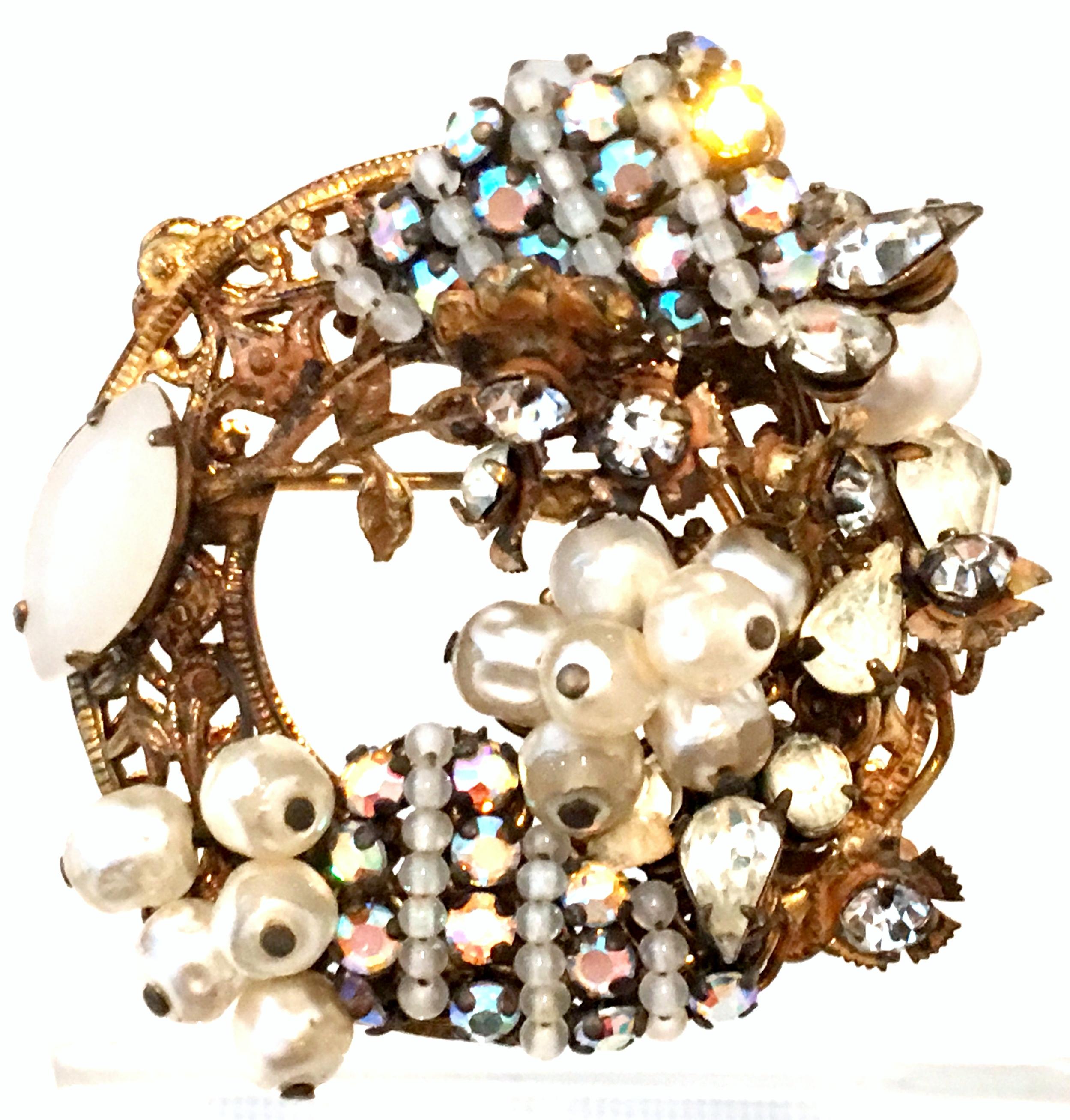 Mid-20th Century Antiqued Gold Plate , Faux Pearl, & Austrian Crystal Round Cluster Brooch by, Original By Robert. This finely crafted piece features a round antiqued gold plate intricate open work base with applied clusters of brilliant cut and