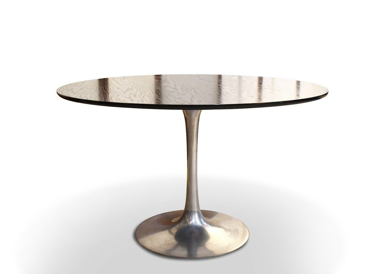 Mid-20th century Arkana dining table with an aluminium base and rare black ash top.

 