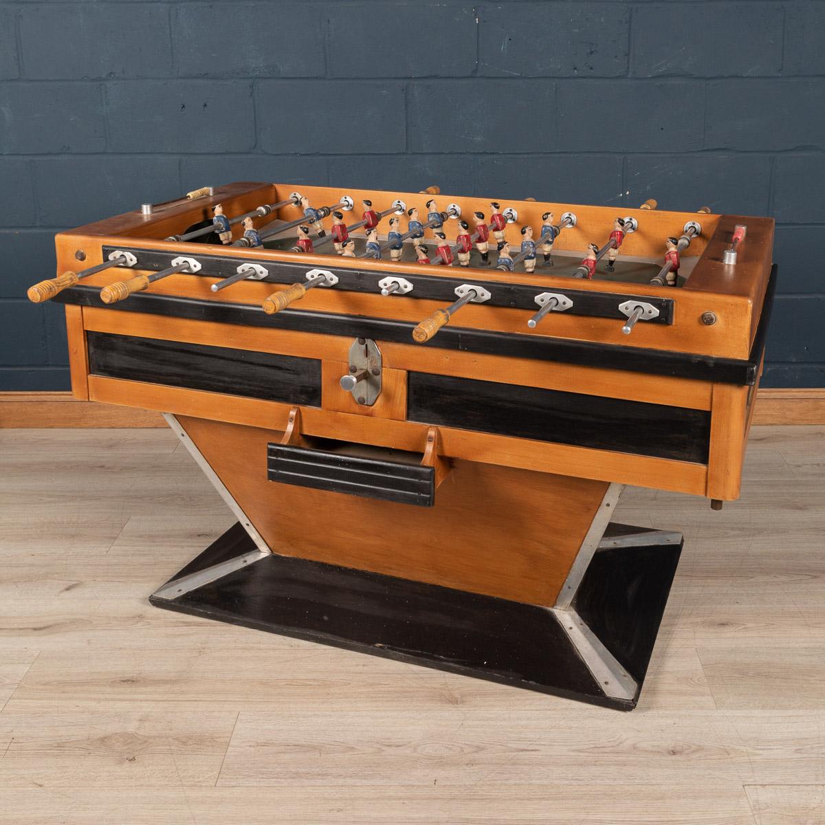 Beautiful French table football game (also known as a foosball table), early to mid-20th century. Painted and varnished wood and chromium plated and other metals, each side with four wooden-handled rods, the footballers of painted wood, a label to