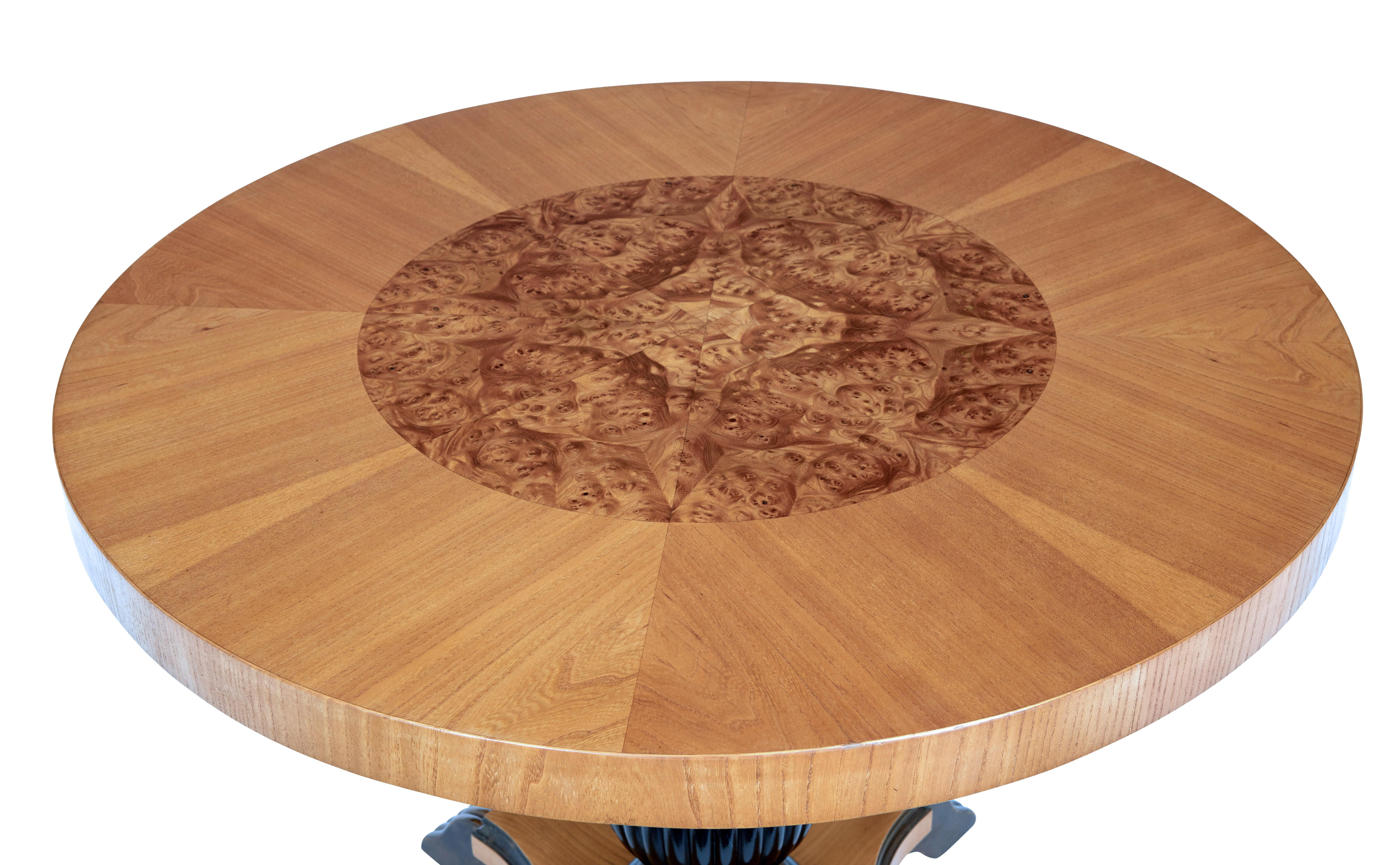 Mid 20th century art deco inspired elm coffee table circa 1950.

Good quality Swedish round coffee table, featuring and inner circle of segmented burr elm surrounded by elm on the outer side. Supported by an ebonised turned and fluted column and