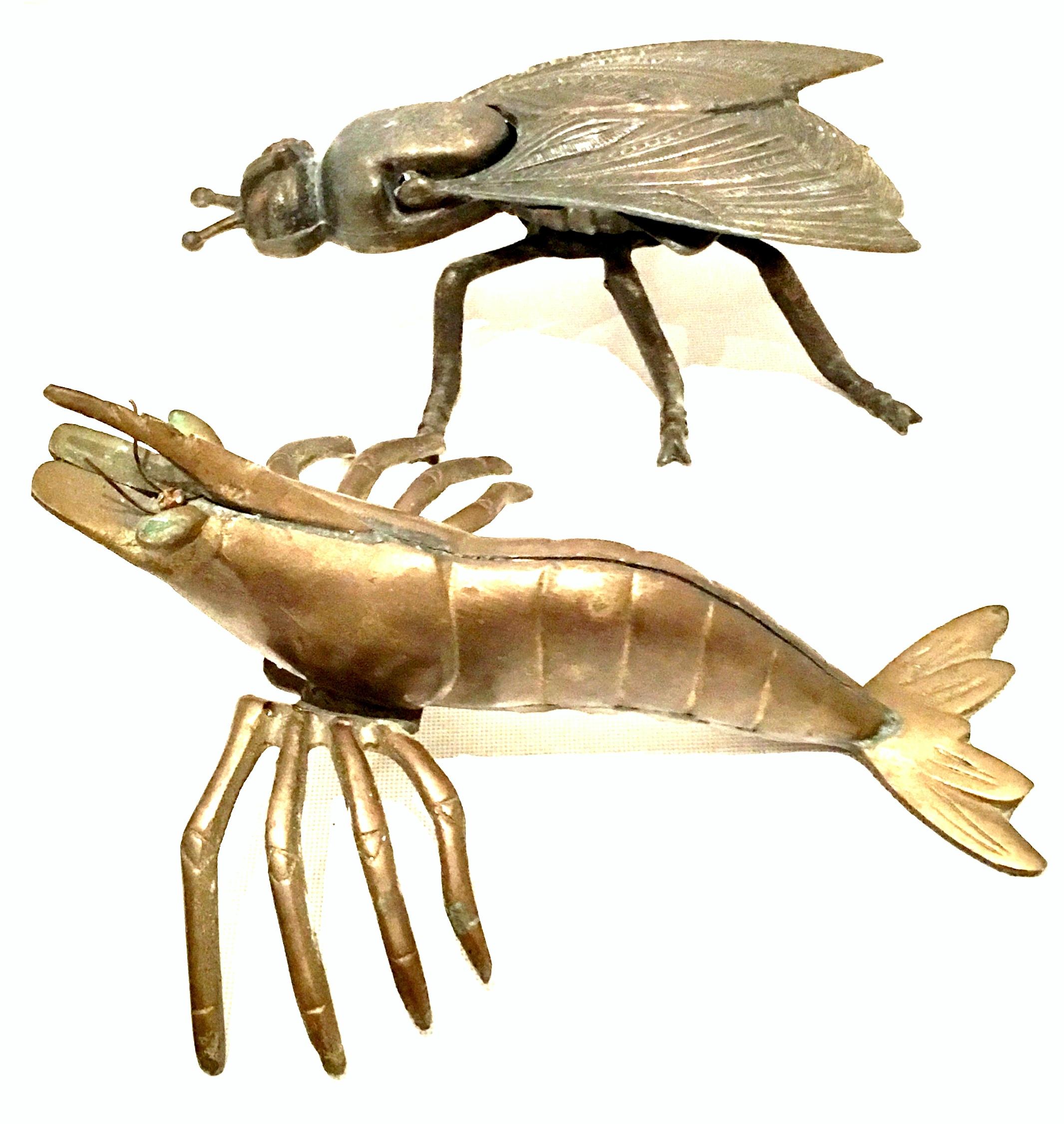 Mid-20th century Art Nouveau pair of iron and brass figural fly and Shrimp Sculptures. The Fly box made of cast iron features a hinged lid. The weighted brass shrimp features attached legs and wire articulating eye detail.
The hinged fly box