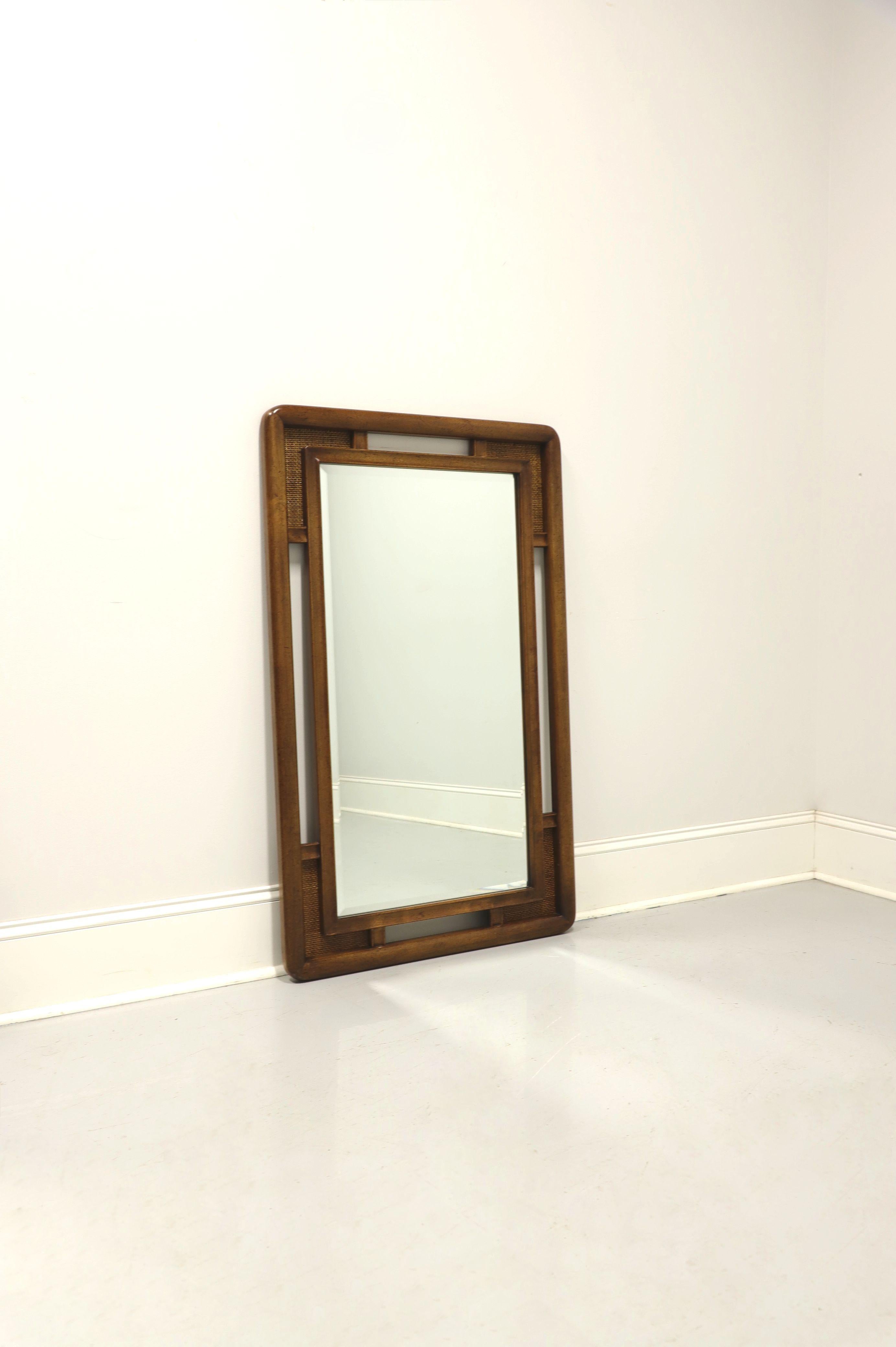 An Asian Style dresser or wall mirror by Unique Furniture. Beveled mirror glass in a nutwood frame with slightly distressed finish and decorative cane accents to the four corners. Made in Winston-Salem, North Carolina, USA, in the mid 20th Century.