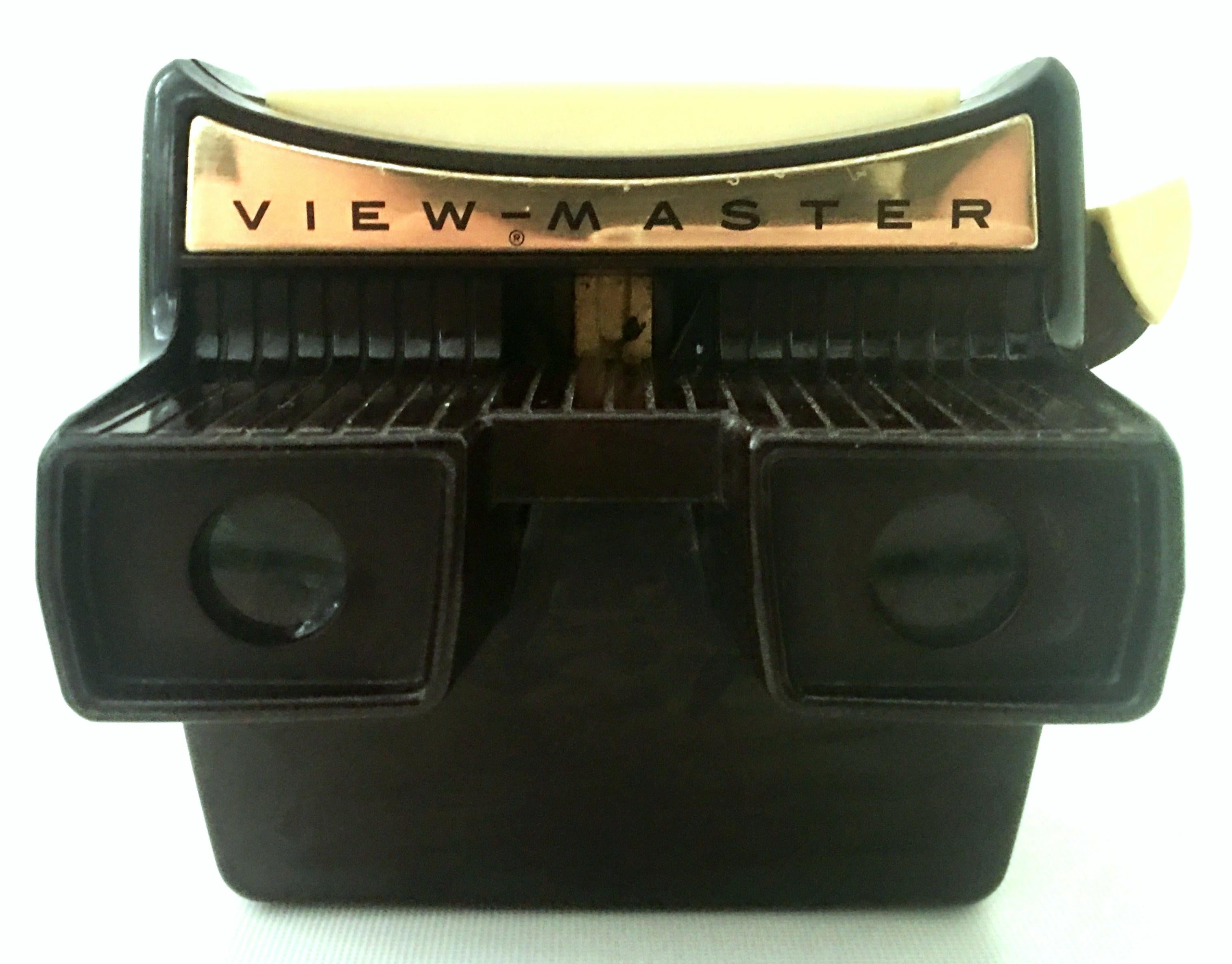 Mid-20th century Bakelite 3-D view - Master with battery operated light and 10 reels by, Sawyer's Inc. The View Master is an organic form owl shape in brown Bakelite with battery operated switch, fully operational. Marked Sawyer's Inc. Portland,