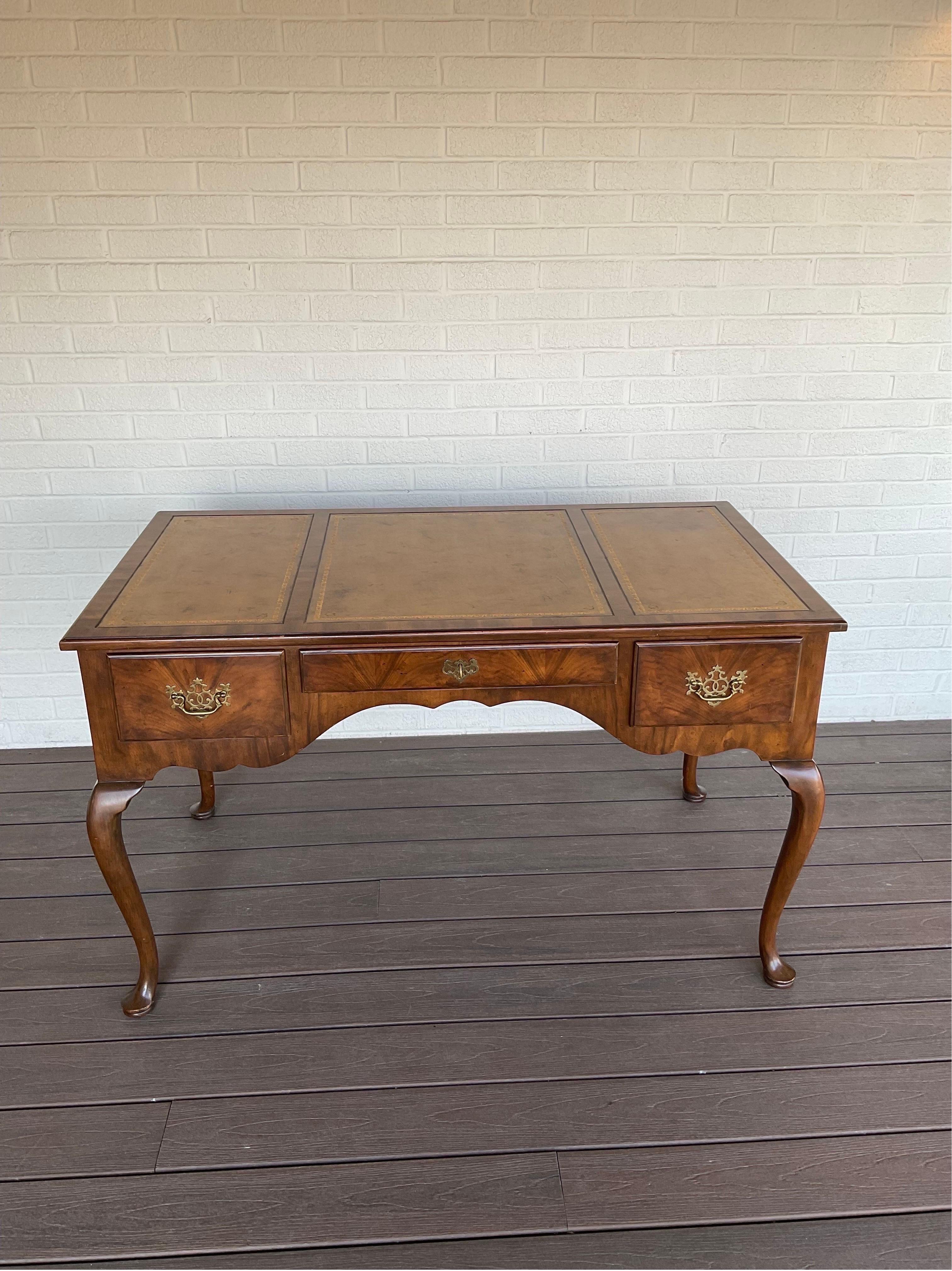 Beautiful example of this intentionally distressed leather top Queen Ann Desk with cabriolet legs and key from Baker furniture. One owner find. Signed and numbered piece. Extraordinary grains and patina.

Condition Disclosure:
Please understand