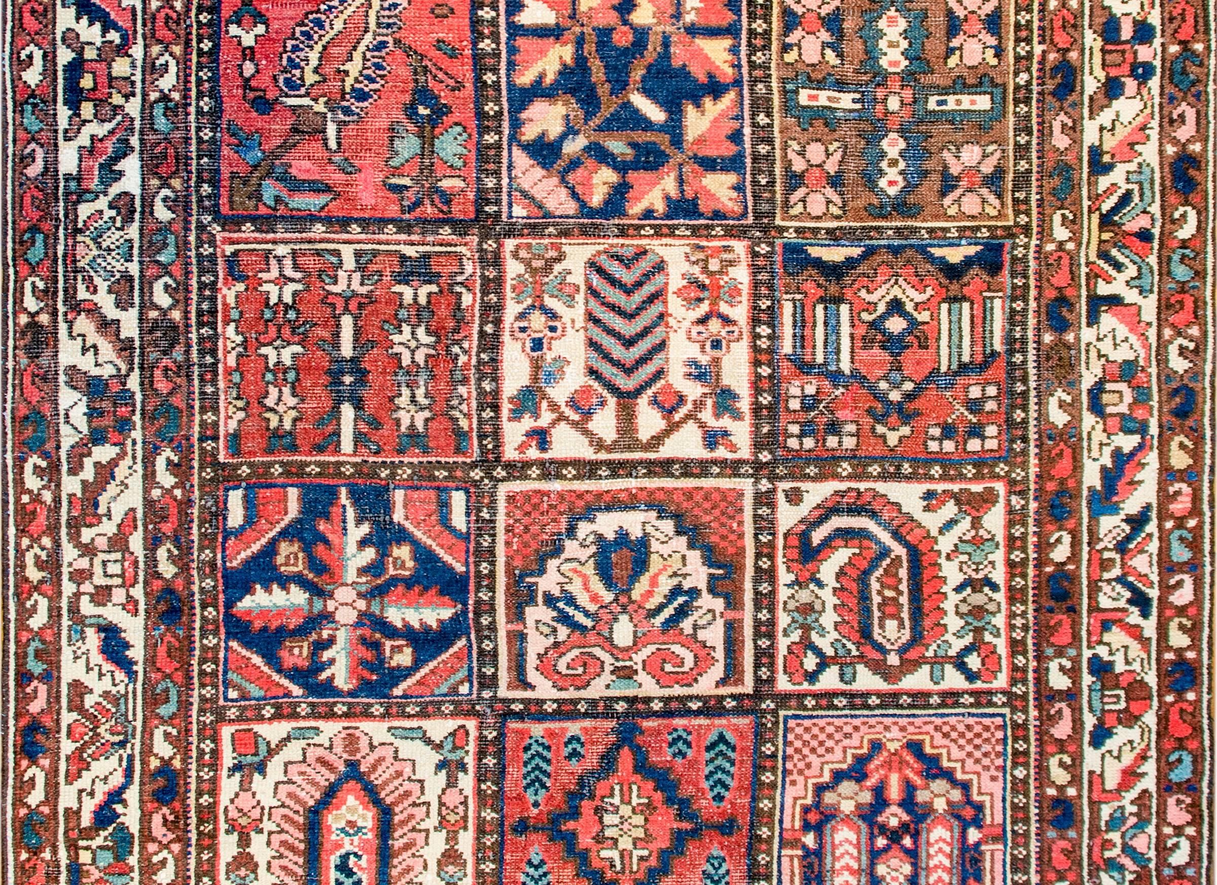 A mid-20th century Persian Bakhtiari rug with a wonderful patchwork quilt-like motif with multiple squares depicting paisleys, trees-of-life, and other flowering branches all woven in varying shades of indigo, crimson, green, and natural wool. The