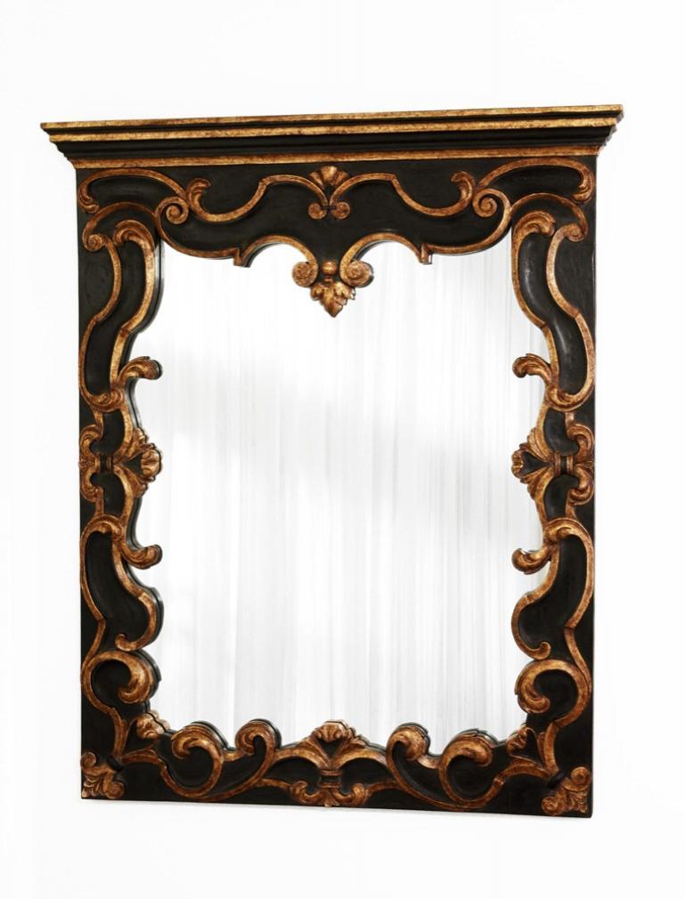 In the Baroque style and based on an overmantel design, with an ebonized and twenty- four carat antiqued gold finish, the rectangular stepped cornice and double c-scroll frieze centering a foliate clasp, carved to the sides and bottom with