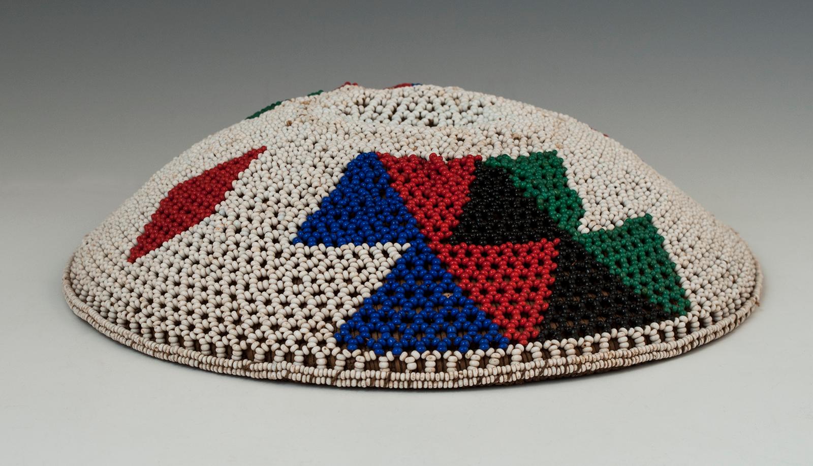 Mid-20th century beer pot cover (Imbengi) Zulu People, South Africa

These beaded covers were used over the mouth of a traditional ceramic beet pot, Ukhamba, to protect the sorghum beer from dust and flies. This is one with a lacy look and is in