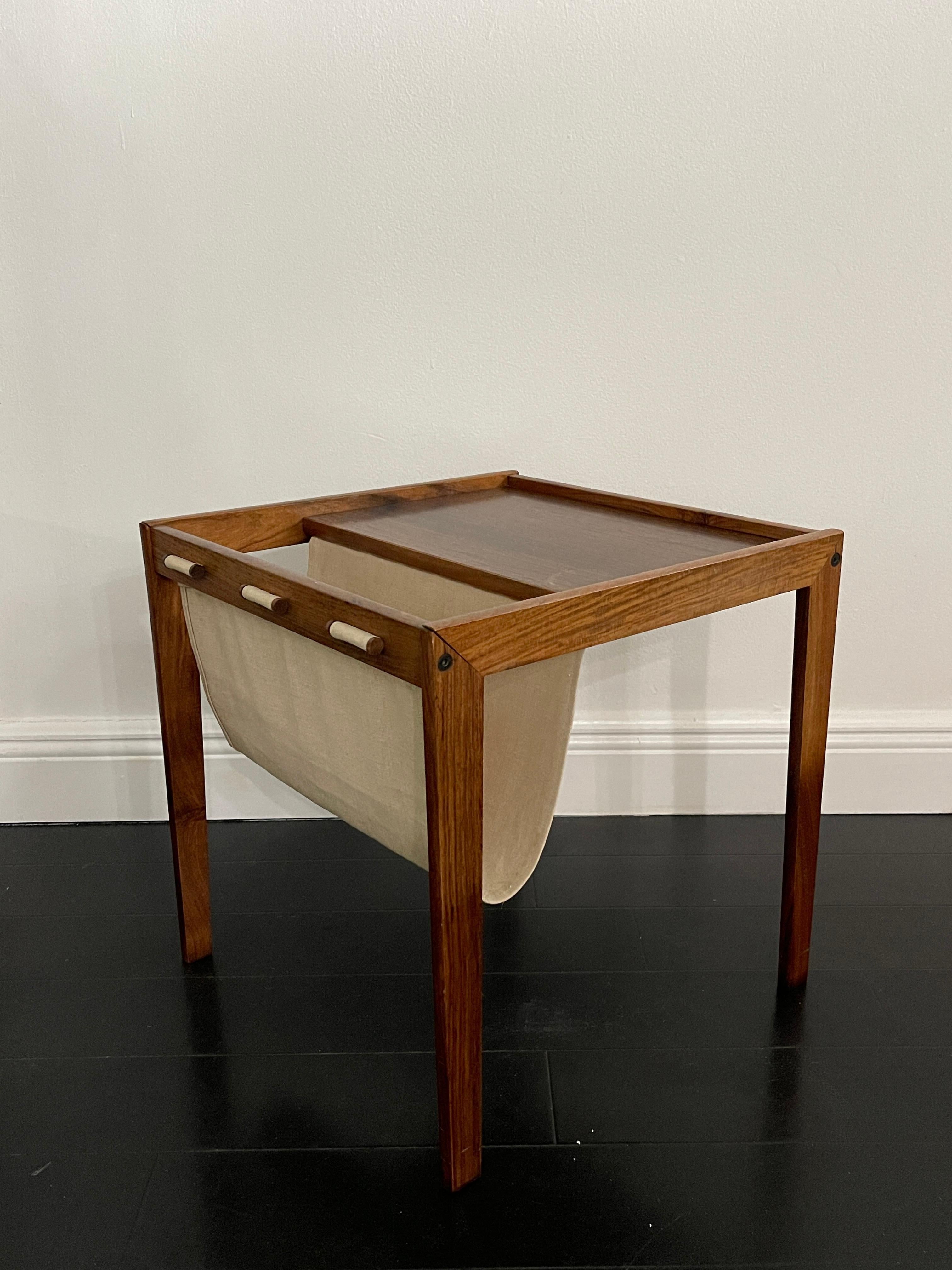 Mid 20th Century Bent Silberg Mobler Danish Modern Magazine Rack / End Table made in Denmark. Perfect side table / end table with a built on canvas magazine holder. Beautiful design with a stamped signature underneath. 