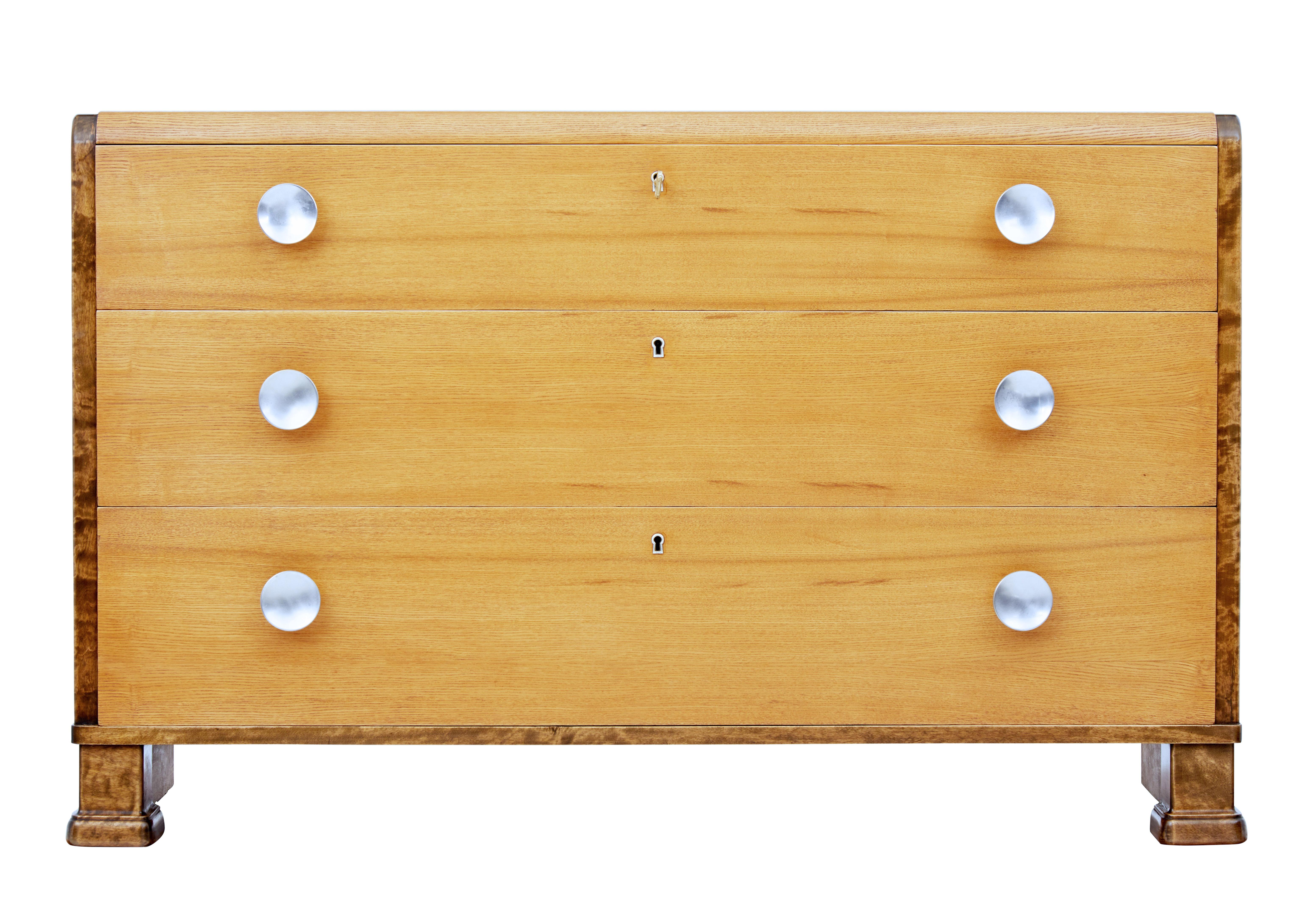 Stunning Scandinavian Modern chest of drawers, circa 1950.

Rich elm 3-drawer chest of drawers, with brushed steel handles. Shaped rounded top with burr birch sides.

A fine example of Scandinavian deco furniture.